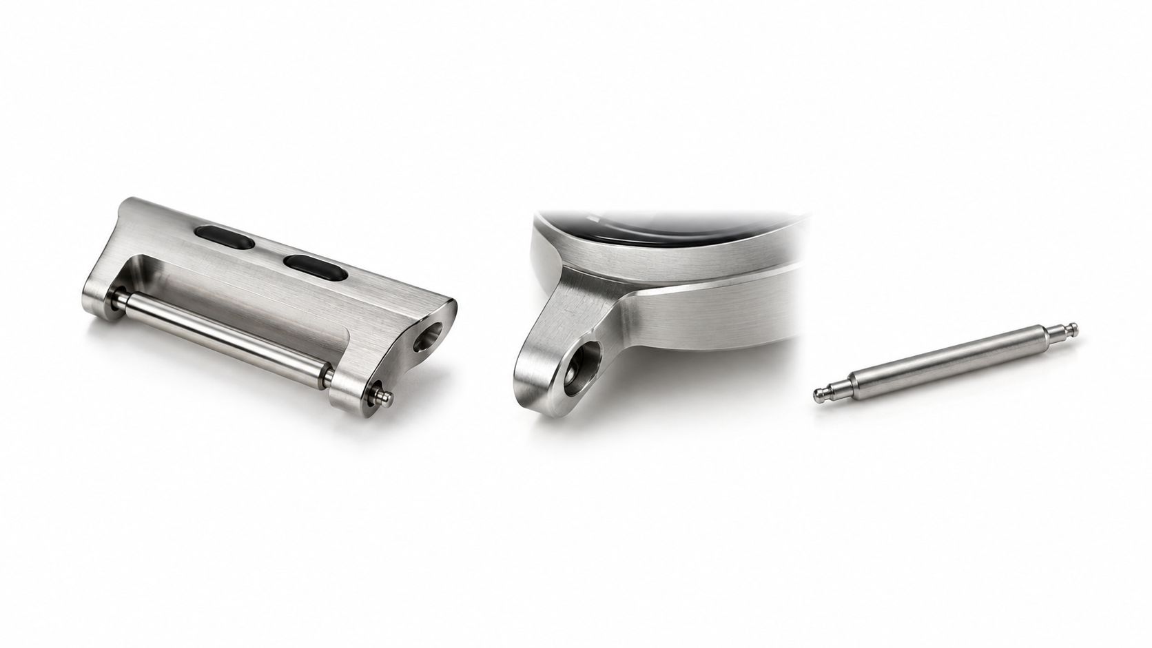 A close-up view of a metal watch strap adapter alongside a watch lug and spring bar.