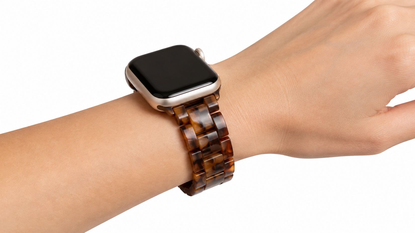 A close-up view of a person wearing a stylish brown tortoiseshell resin watch band on an Apple Watch.