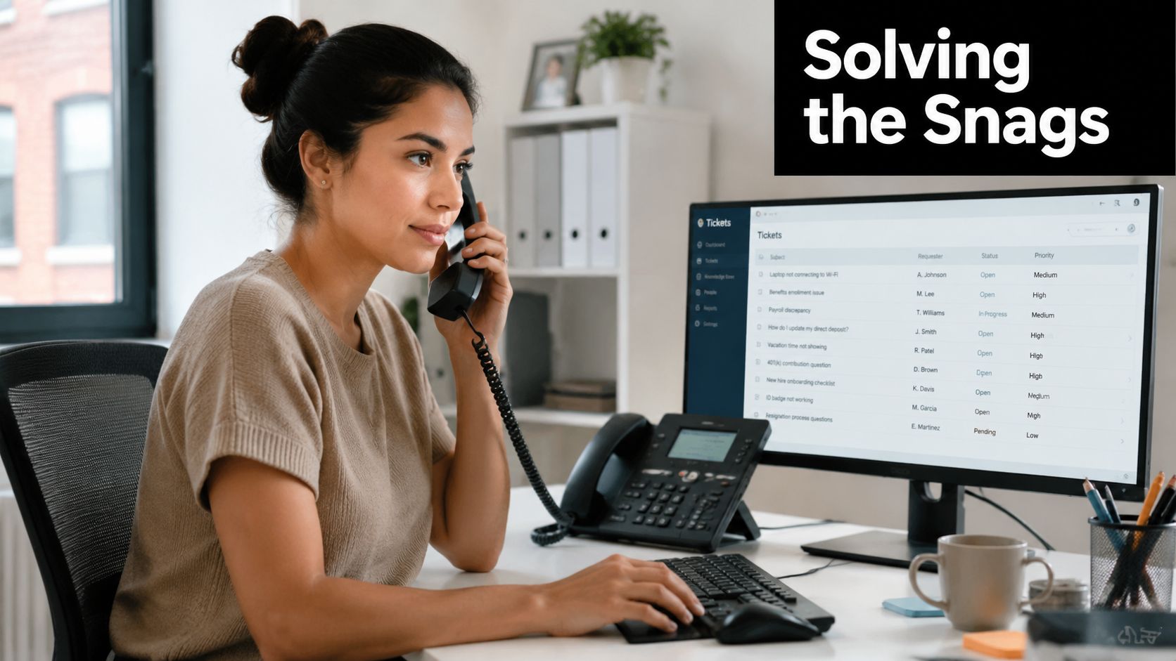 A professional woman talking on the phone while managing IT help desk tickets on her computer monitor.