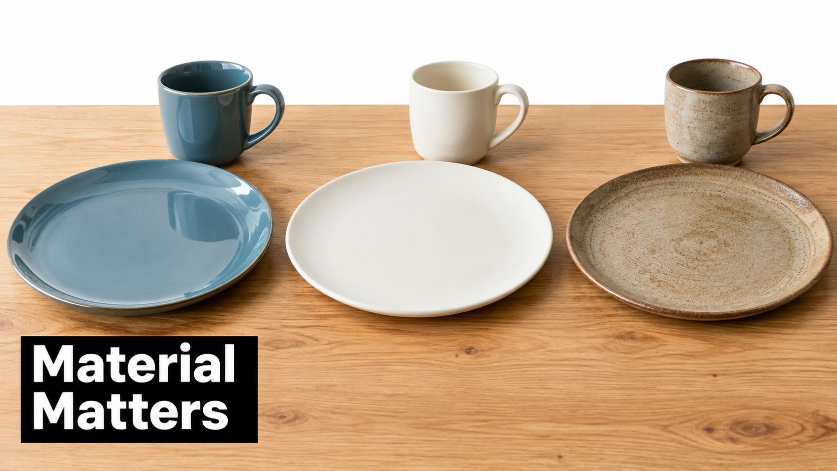 A set of three different colored ceramic dinner plates and matching mugs arranged on a wooden table.