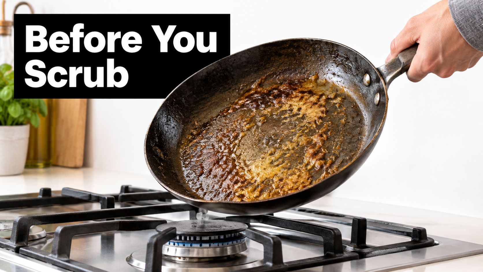 A dirty frying pan with residue being held over a gas stove burner in a kitchen.