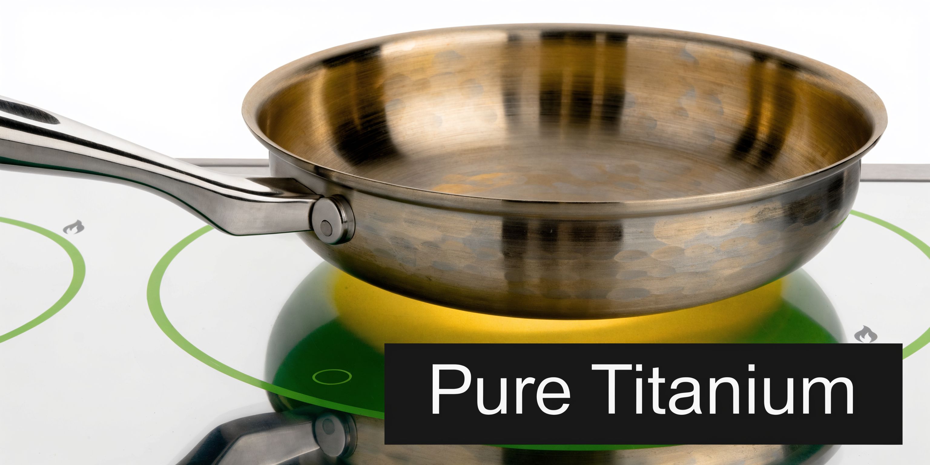 A premium titanium frying pan resting on a modern induction cooktop with a reflective glass surface.