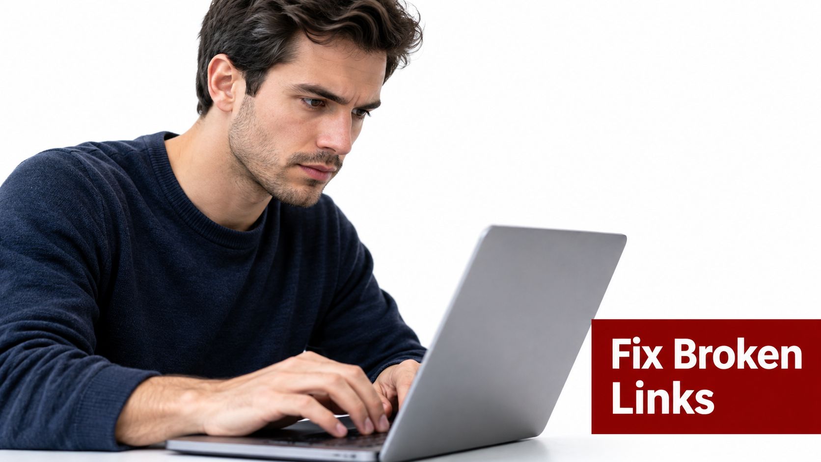 A focused man working intently on a laptop computer to repair broken links on a website.