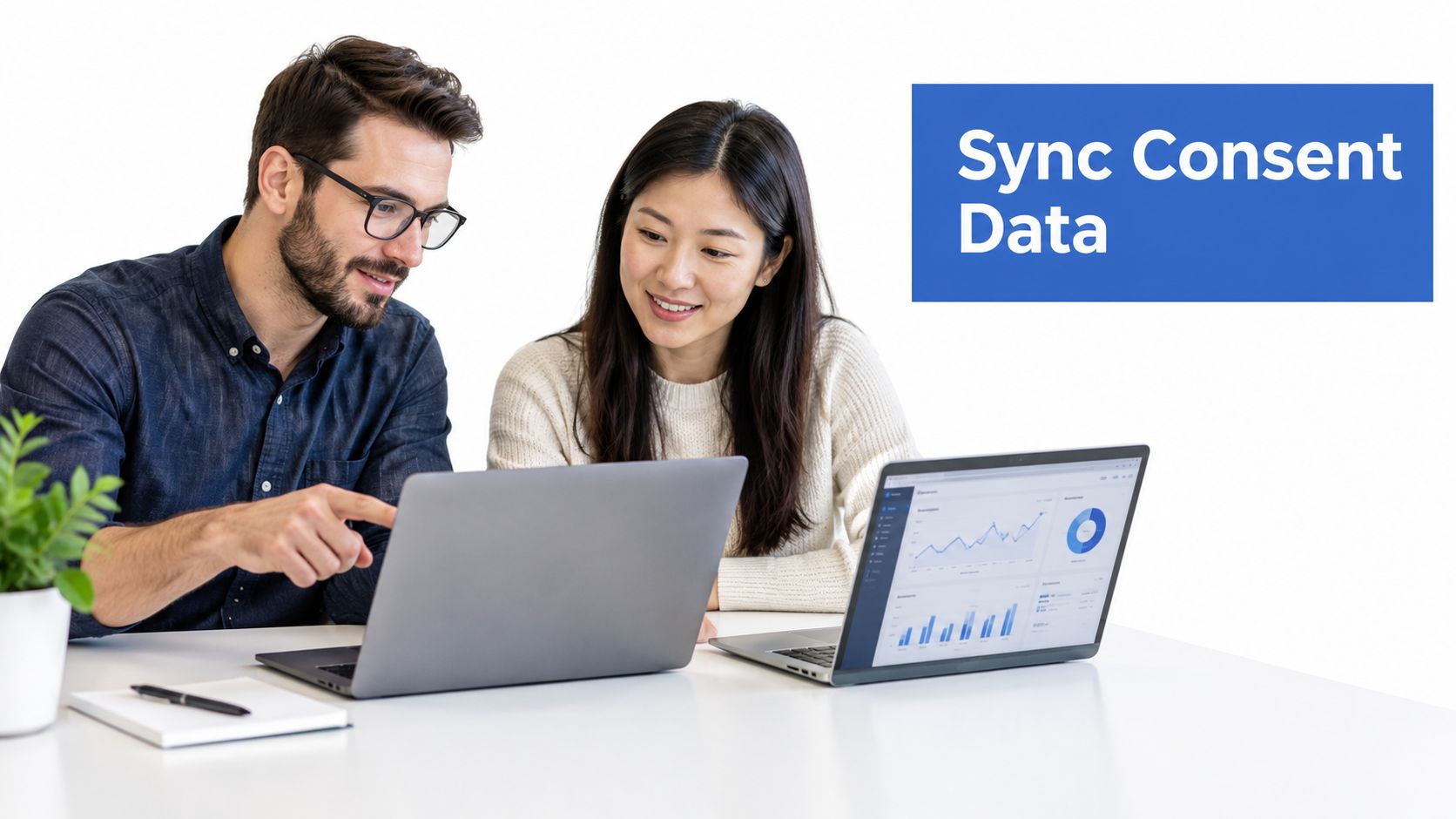 A professional man and woman collaborating on a laptop project related to digital consent data management.