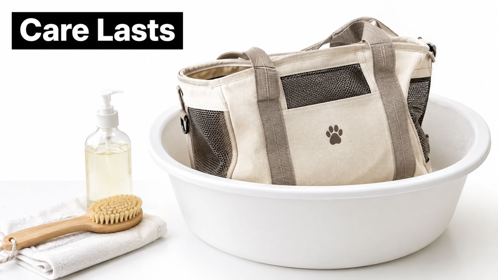 A canvas pet carrier tote sits inside a large white washing basin with cleaning soap and brush.
