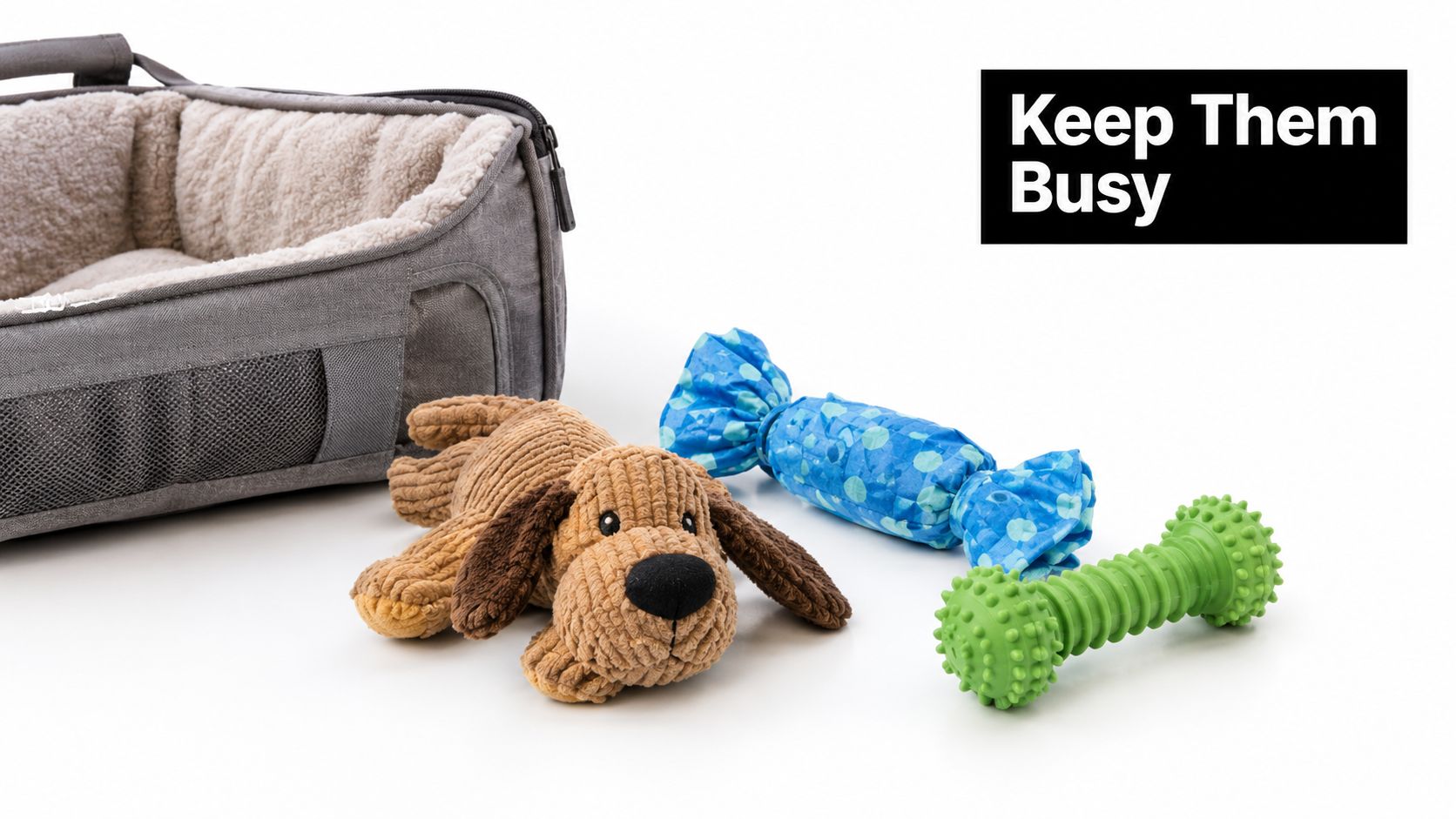 A gray pet travel bed next to a stuffed dog toy, candy toy, and green chew toy.