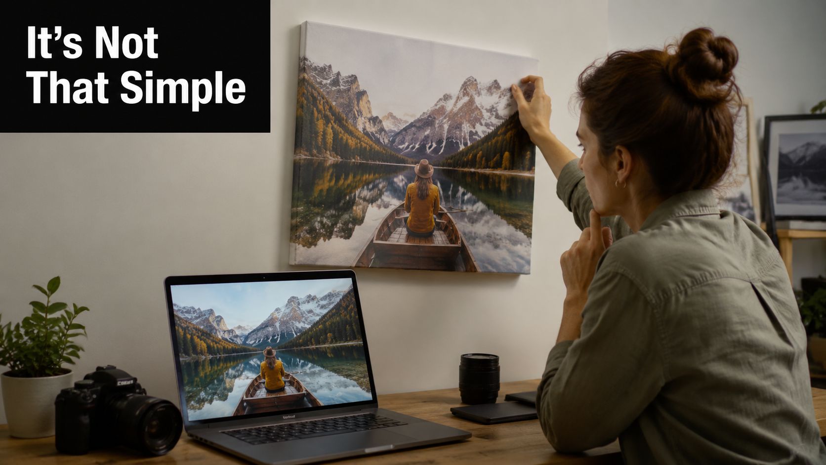 A woman admiring her custom canvas photo print of a mountain lake scene hanging on a wall.