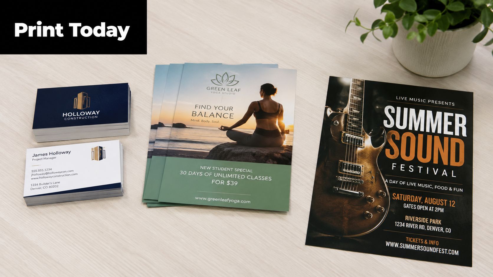 An overhead view of business cards, a yoga flyer, and a music festival flyer on a desk.
