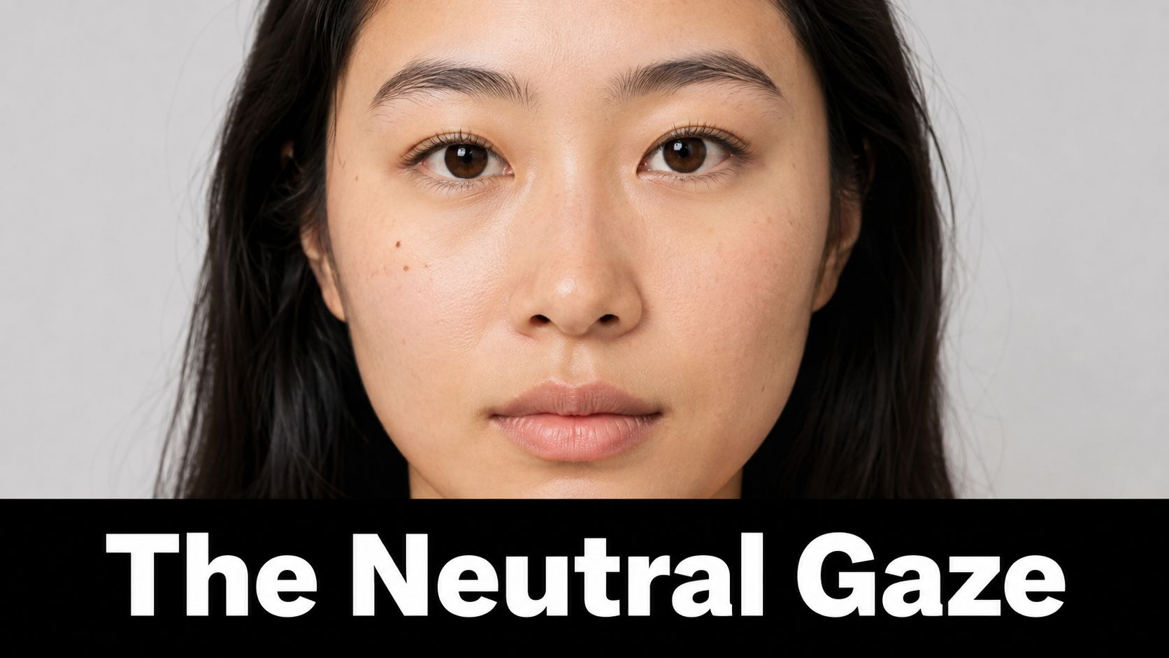 A portrait of a young woman with a neutral facial expression posing for a passport photograph.
