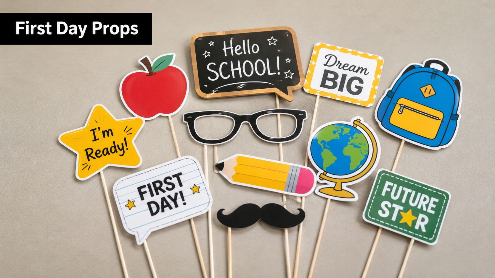 A collection of colorful back to school photo booth props on a light grey background.