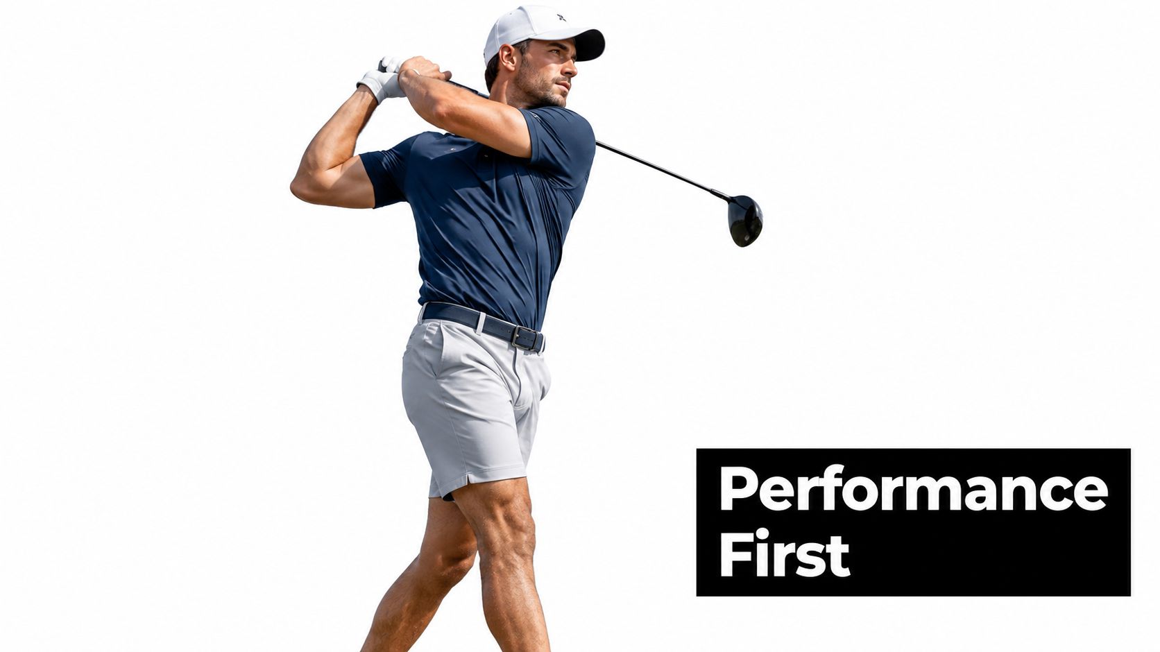 A professional golfer in a navy polo and grey shorts mid-swing with a golf club isolated.