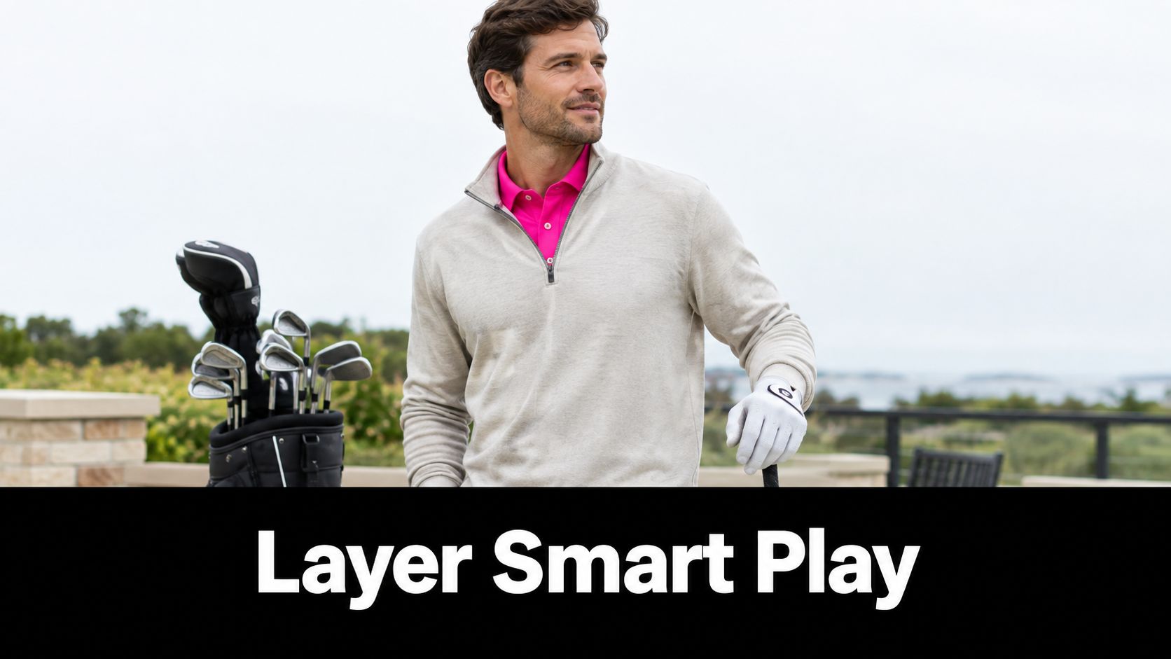 A stylish man wearing a layered sweater and golf shirt stands outdoors with his golf club bag.