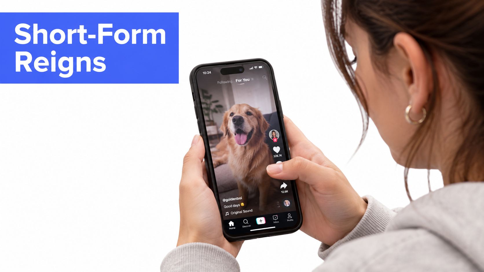 A woman holding a smartphone displaying a viral dog video on a short-form video social media platform.