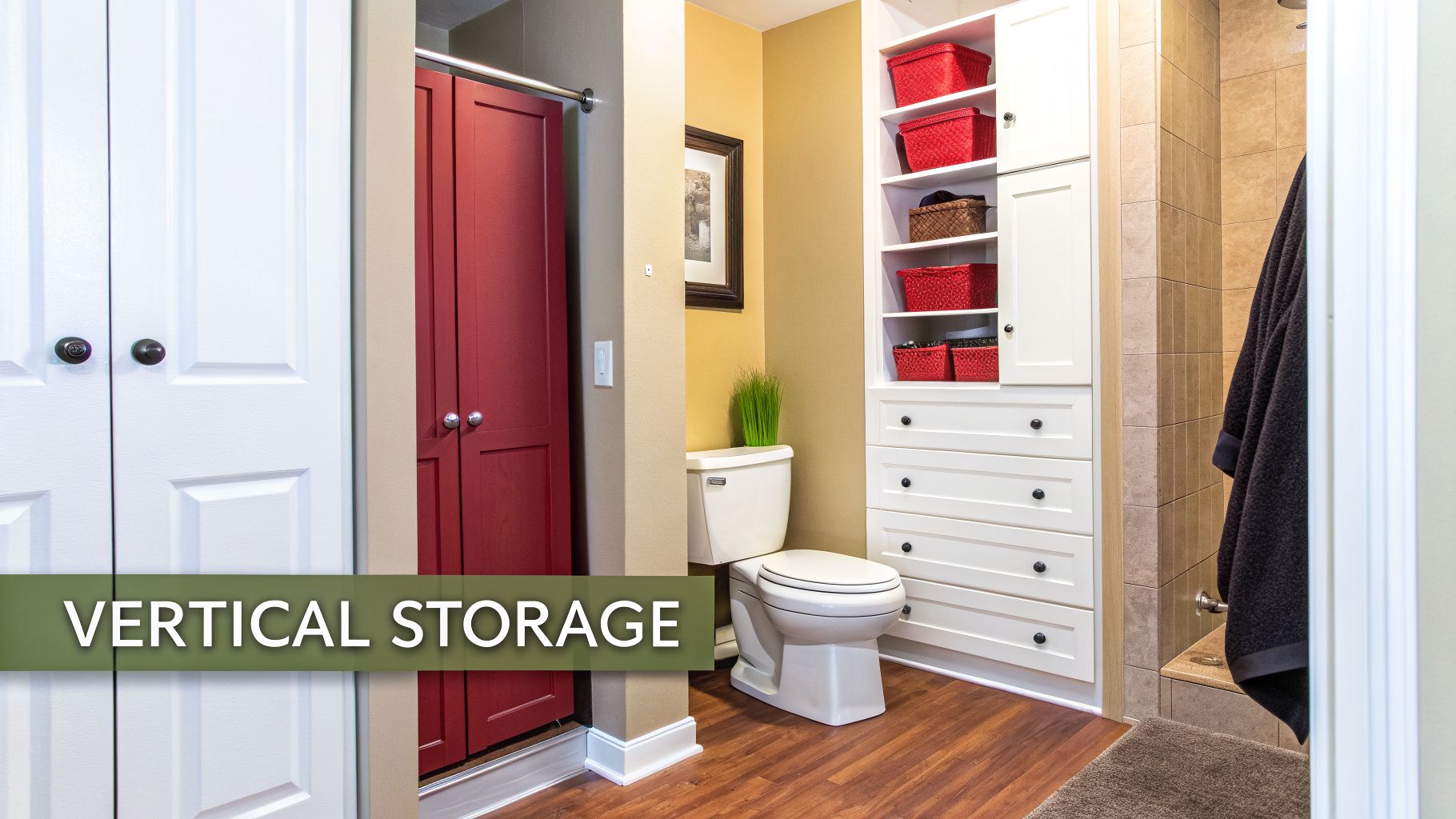 A well-organized small bathroom with white and red closets, a toilet, and built-in vertical storage shelves with baskets.
