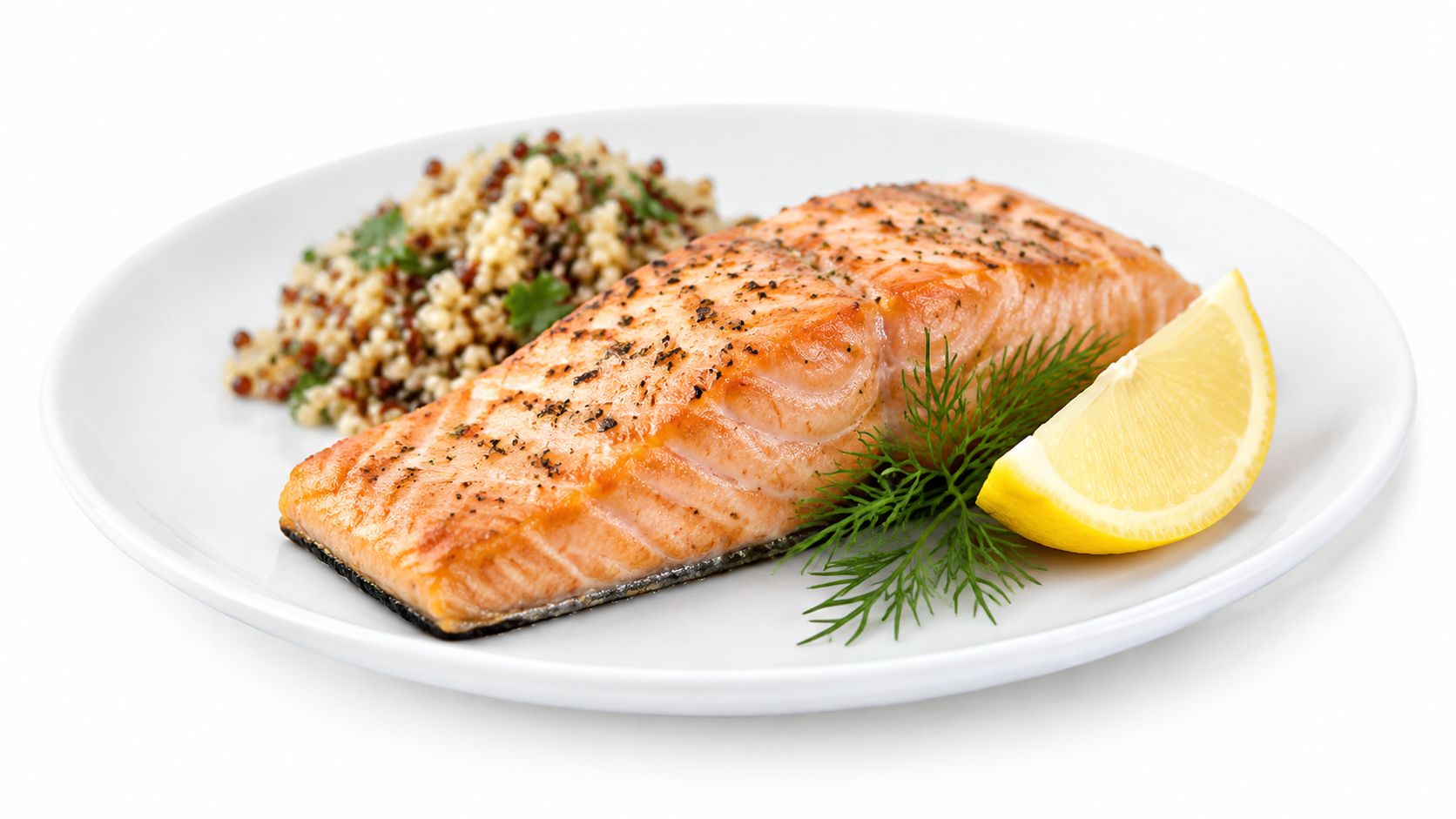 A delicious cooked salmon fillet served with grains and a lemon wedge on a white plate.