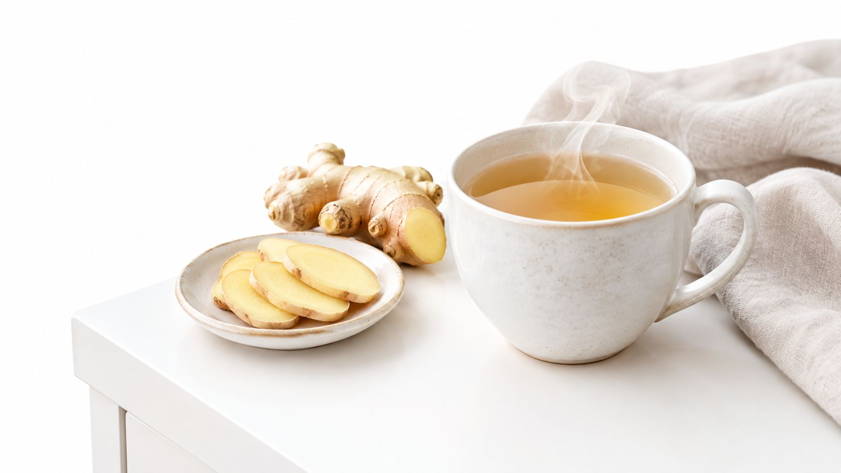 A warm cup of steaming ginger tea served with fresh ginger slices on a small white plate.