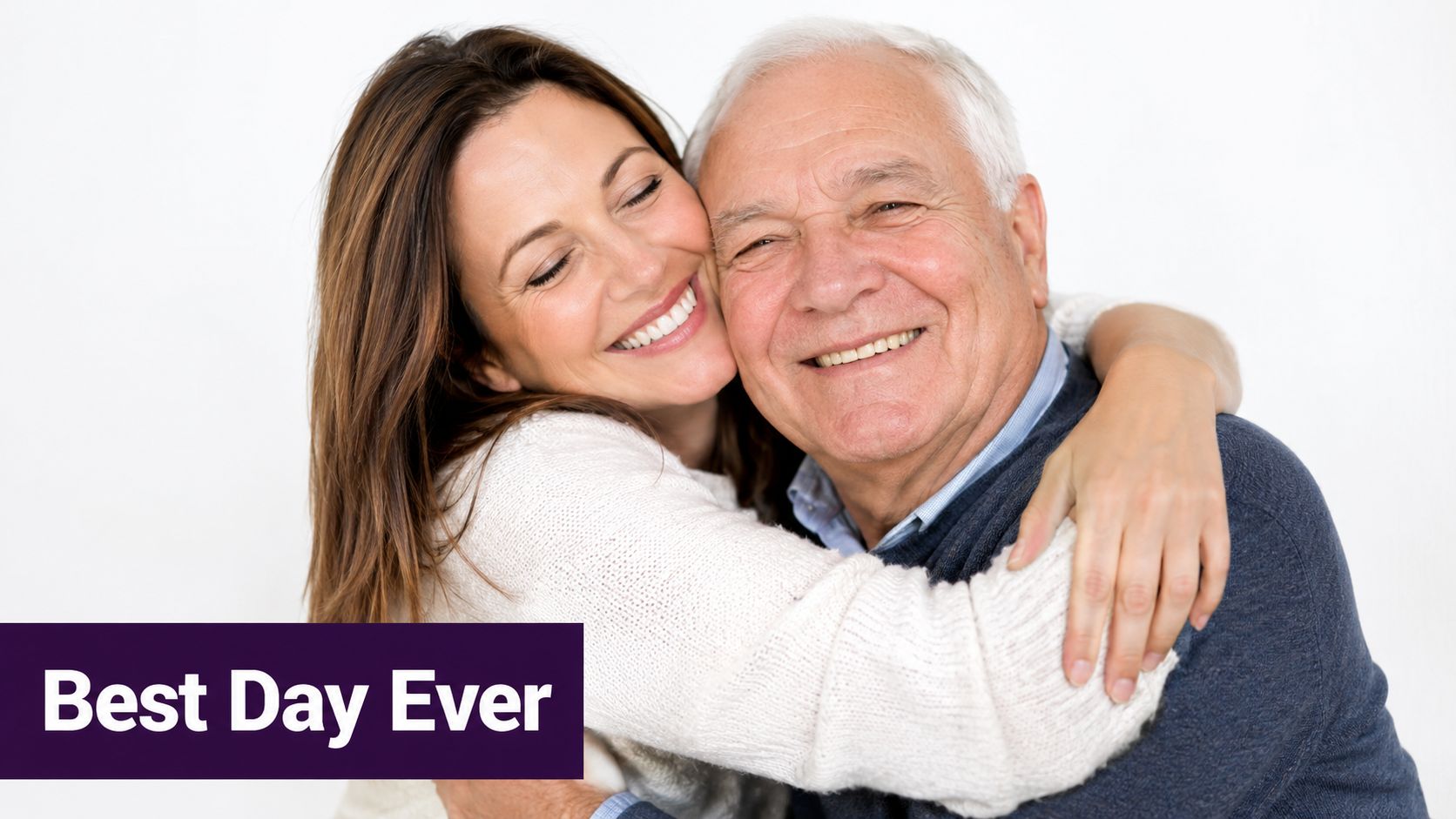 A young woman smiling and warmly hugging an older man against a simple white background.