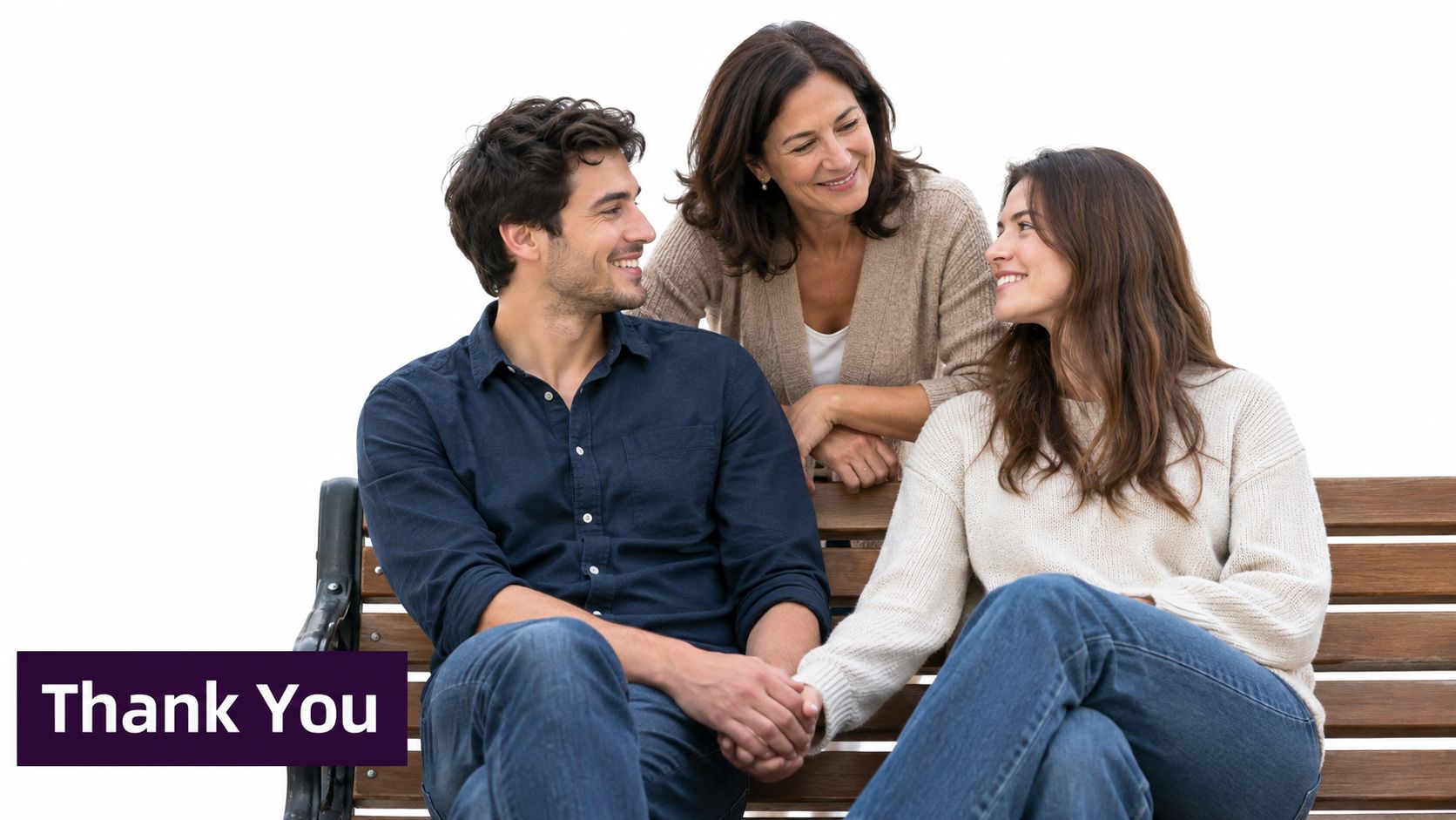 A happy woman and young couple sitting together on a park bench, looking at each other warmly.