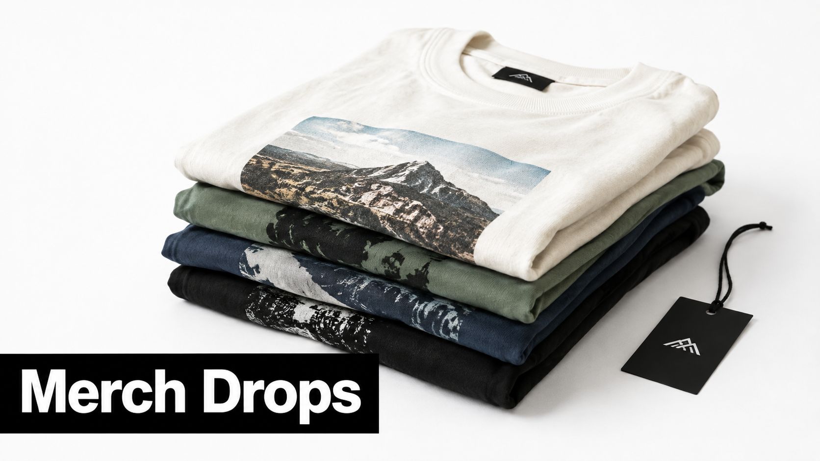 A stack of folded t-shirts in beige, green, blue, and black, featuring mountain graphics and brand labels.