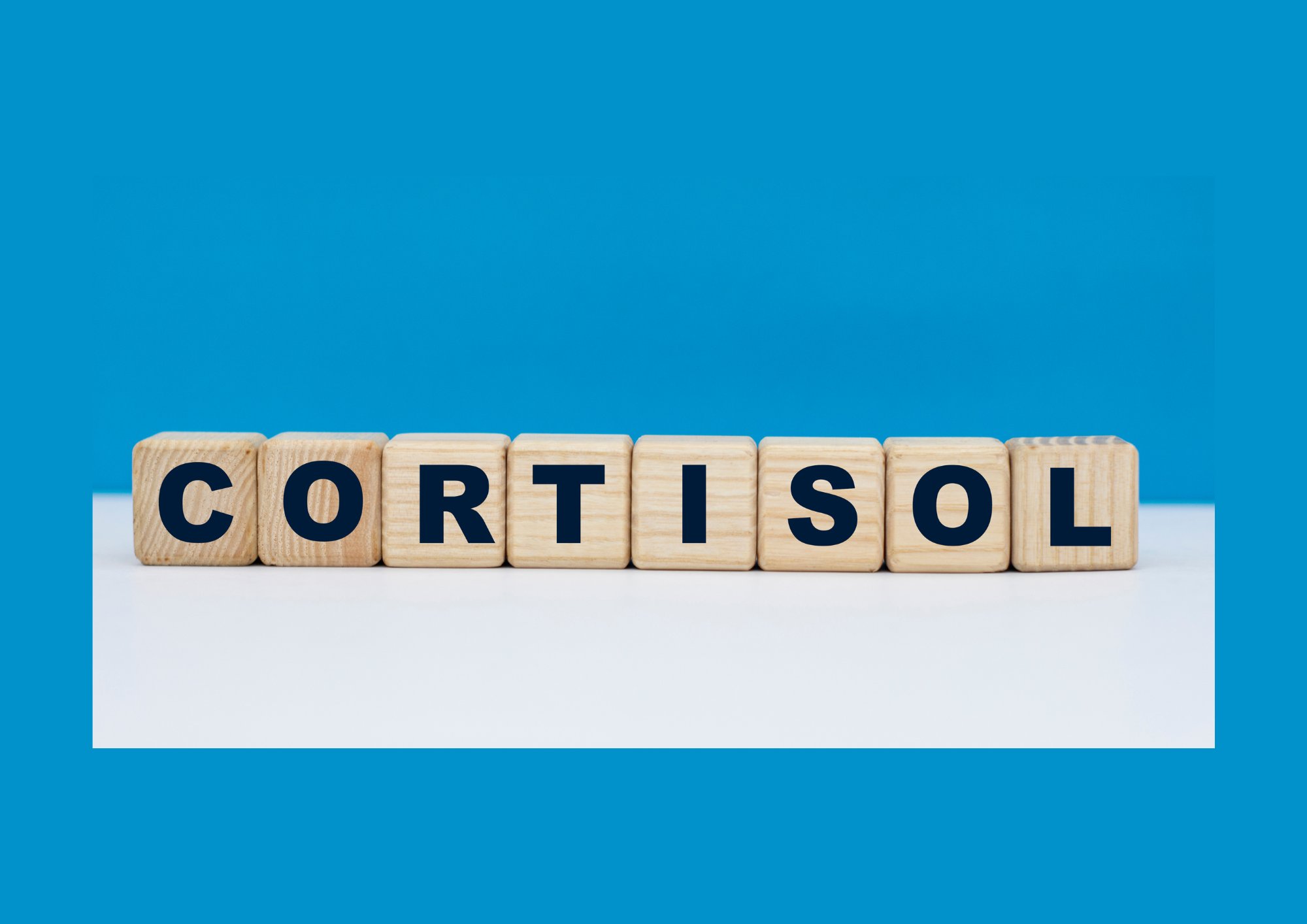 Cortisol spelled out in wooden letter blocks on a blue and white background.