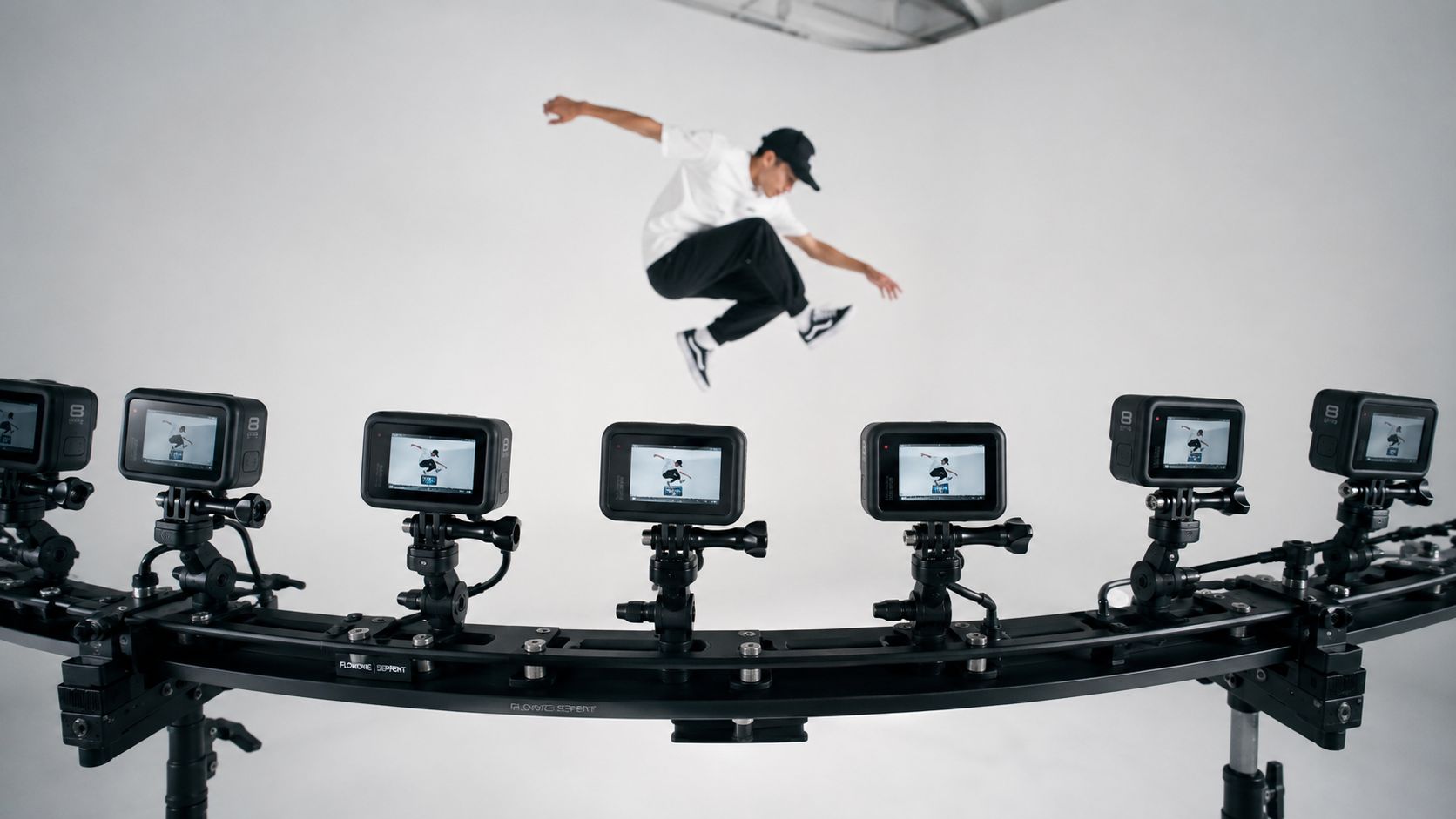 A professional camera rig capturing a man mid-air in a studio to create a bullet time effect.