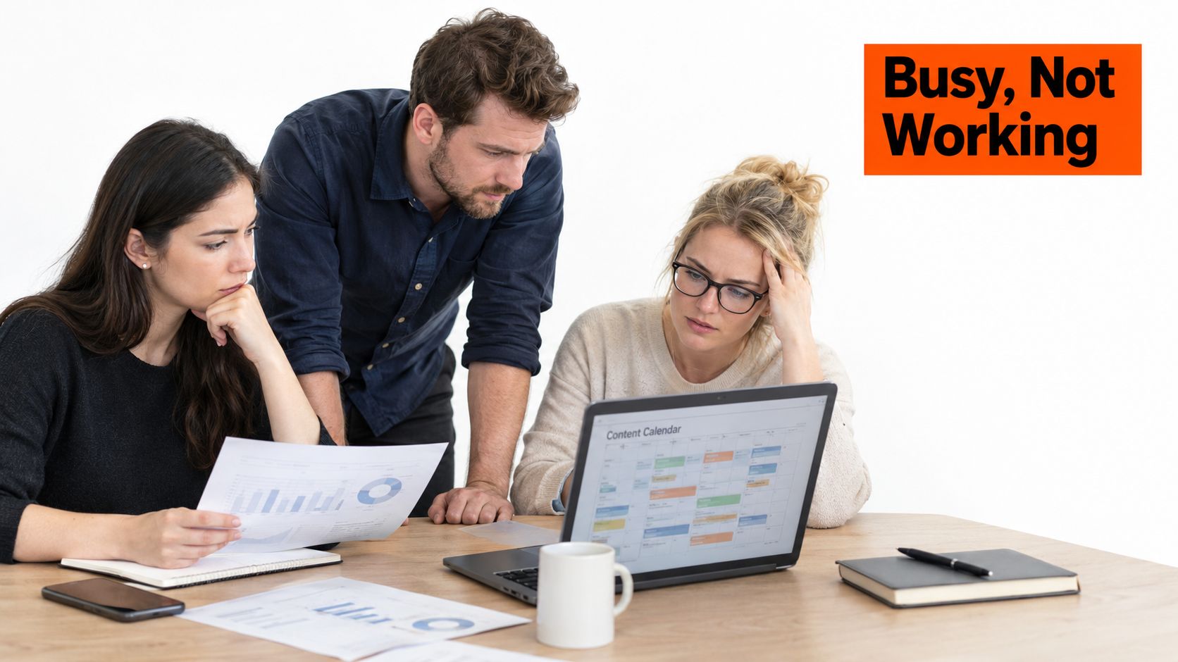 A professional team of three people looking stressed while working on a content calendar project together.