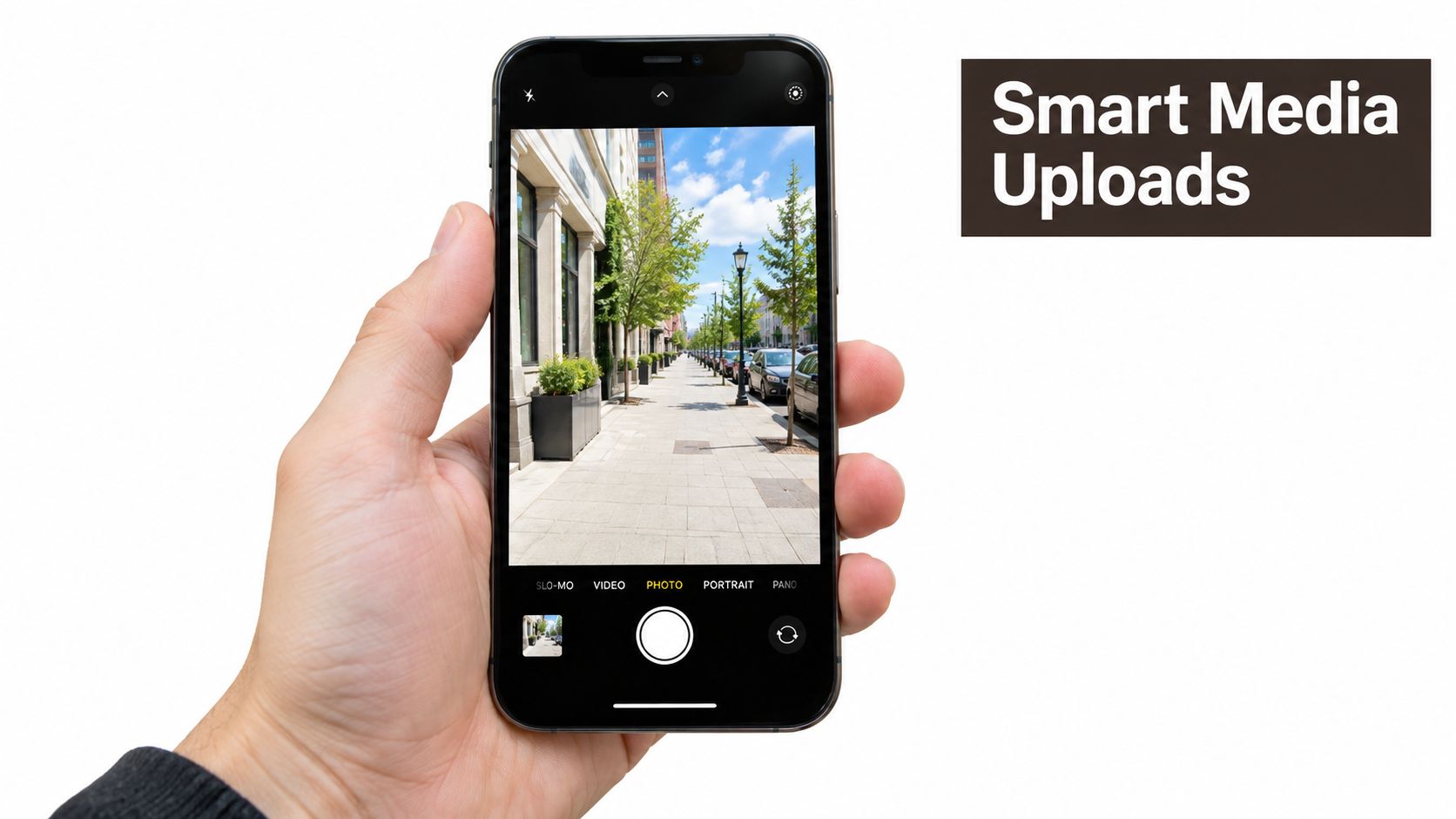 A person holding a smartphone showing a camera interface with a photo of an empty urban sidewalk.