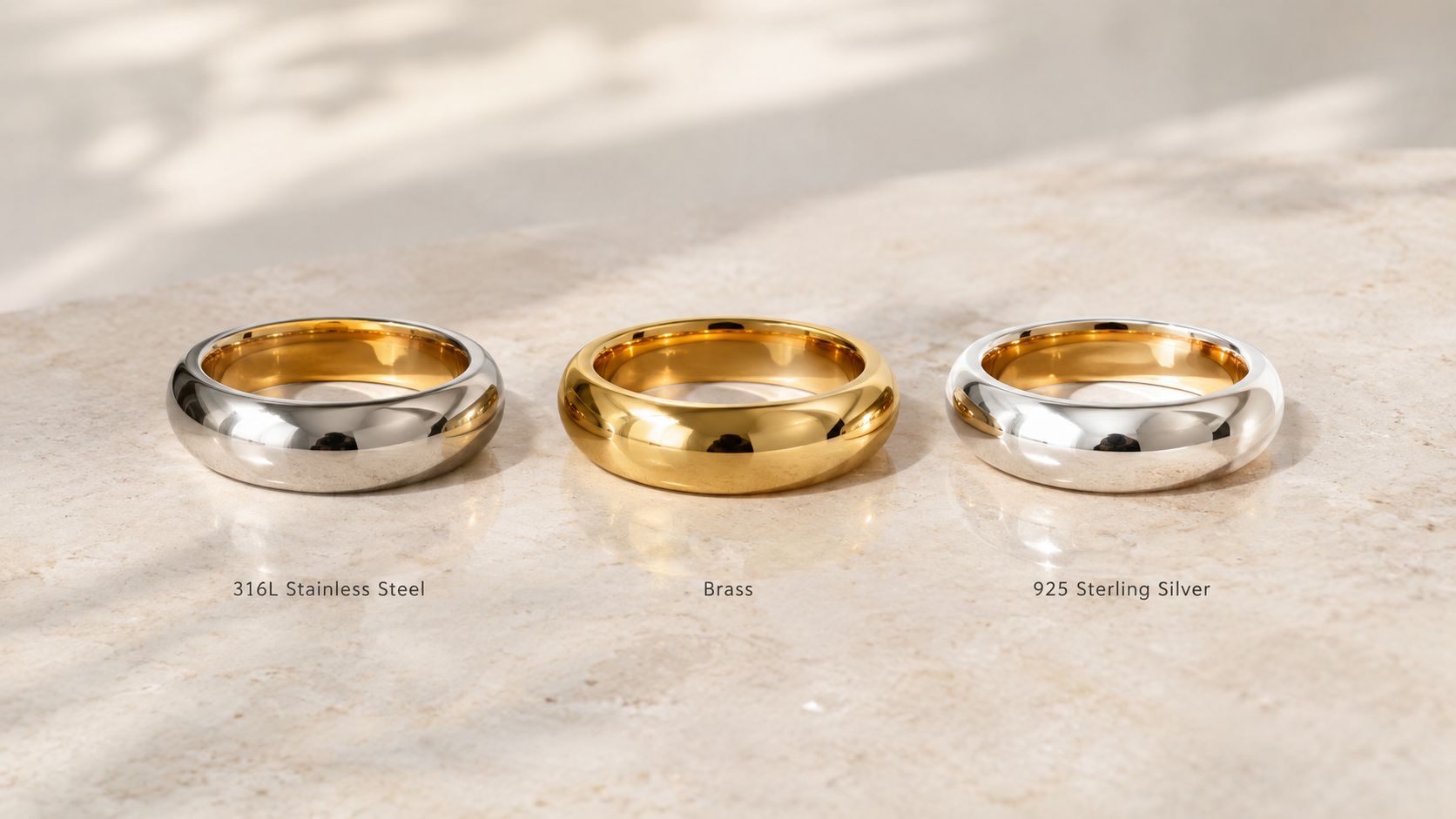 Gold-finished stainless steel, brass and sterling silver rings shown for base-metal comparison.