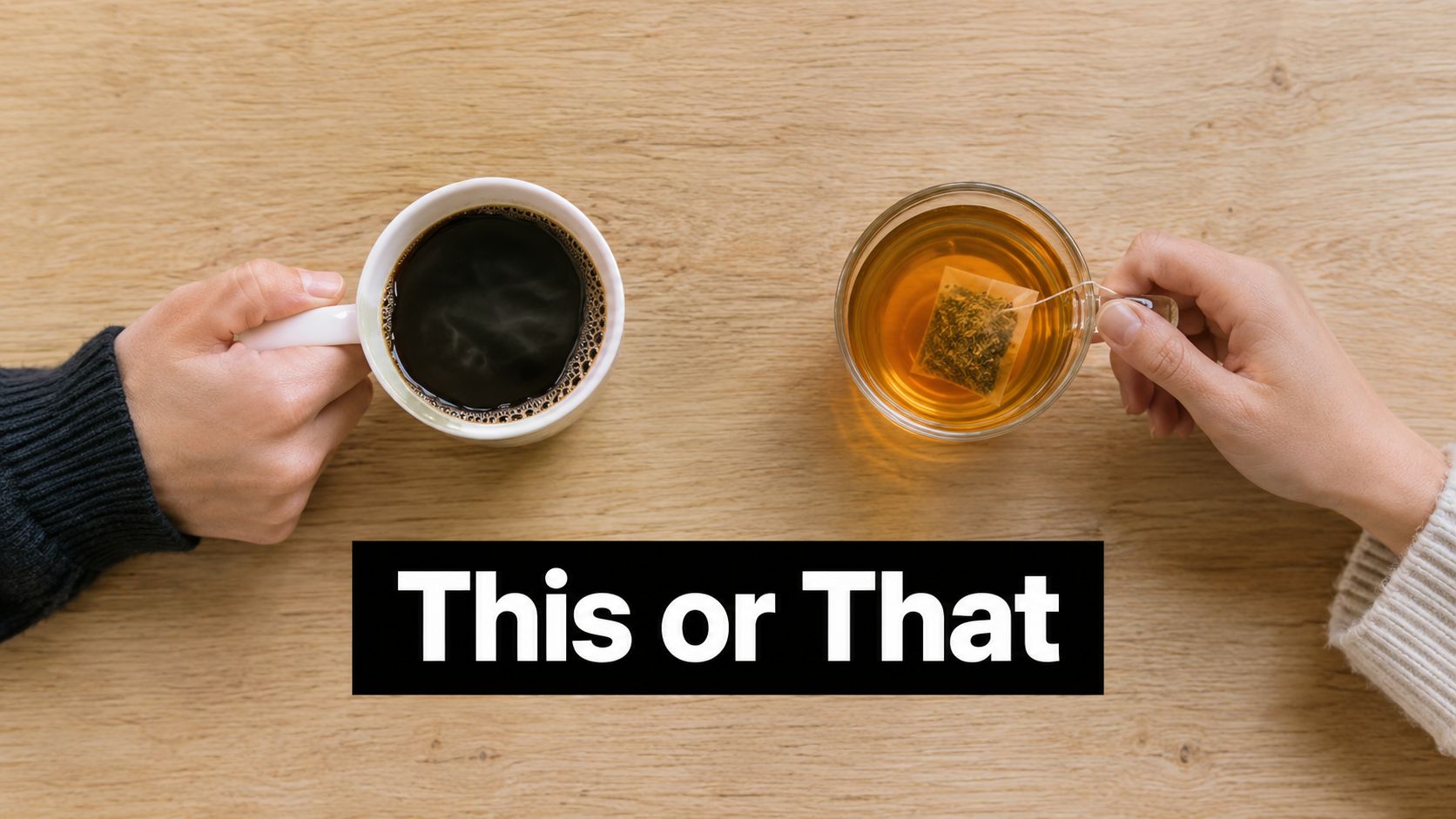 A top-down view of two people holding cups of coffee and tea on a wooden surface.