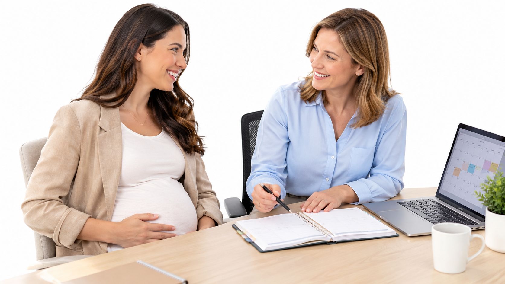 A pregnant woman and her manager reviewing calendar dates for upcoming maternity leave in a bright office.