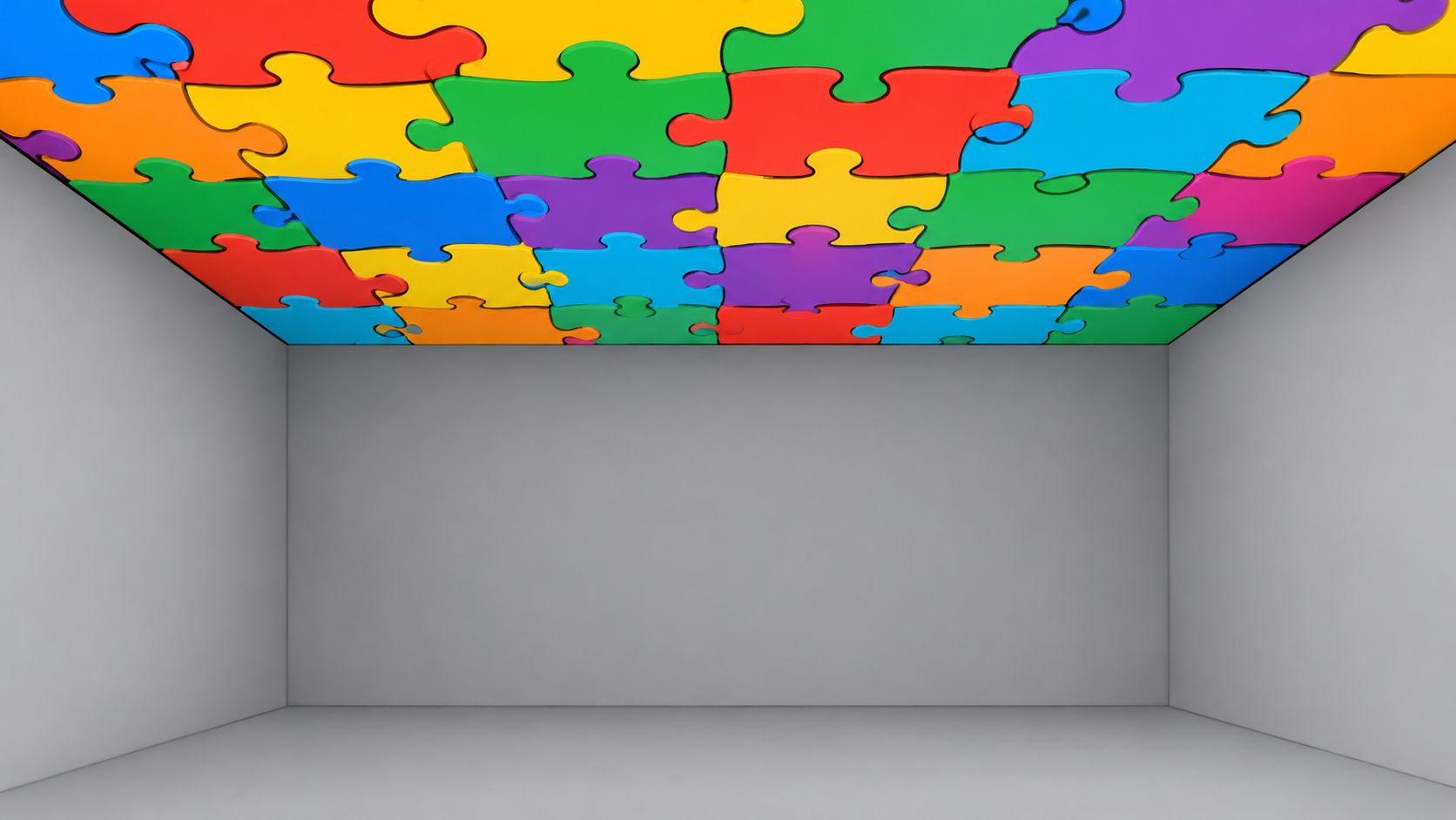 A minimalist room with solid gray walls and floor, featuring a colorful jigsaw puzzle ceiling pattern.