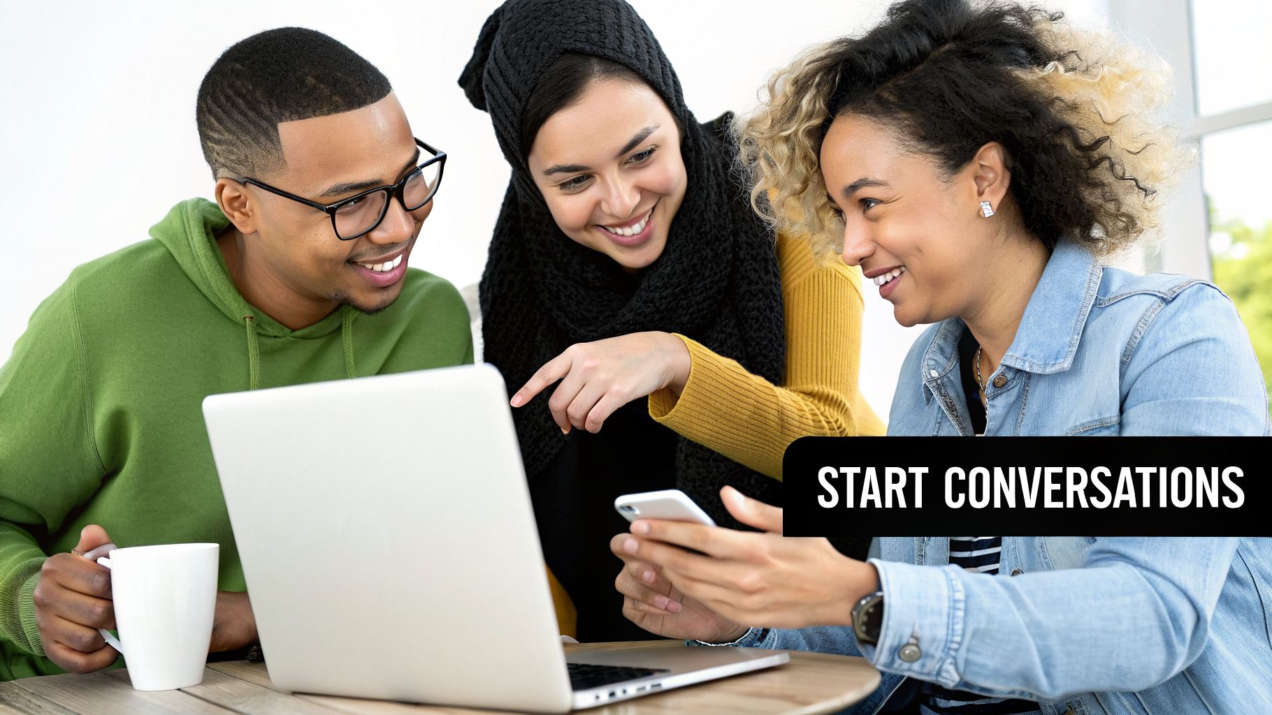 Three diverse young adults smile while collaborating on a laptop, encouraging social conversations.