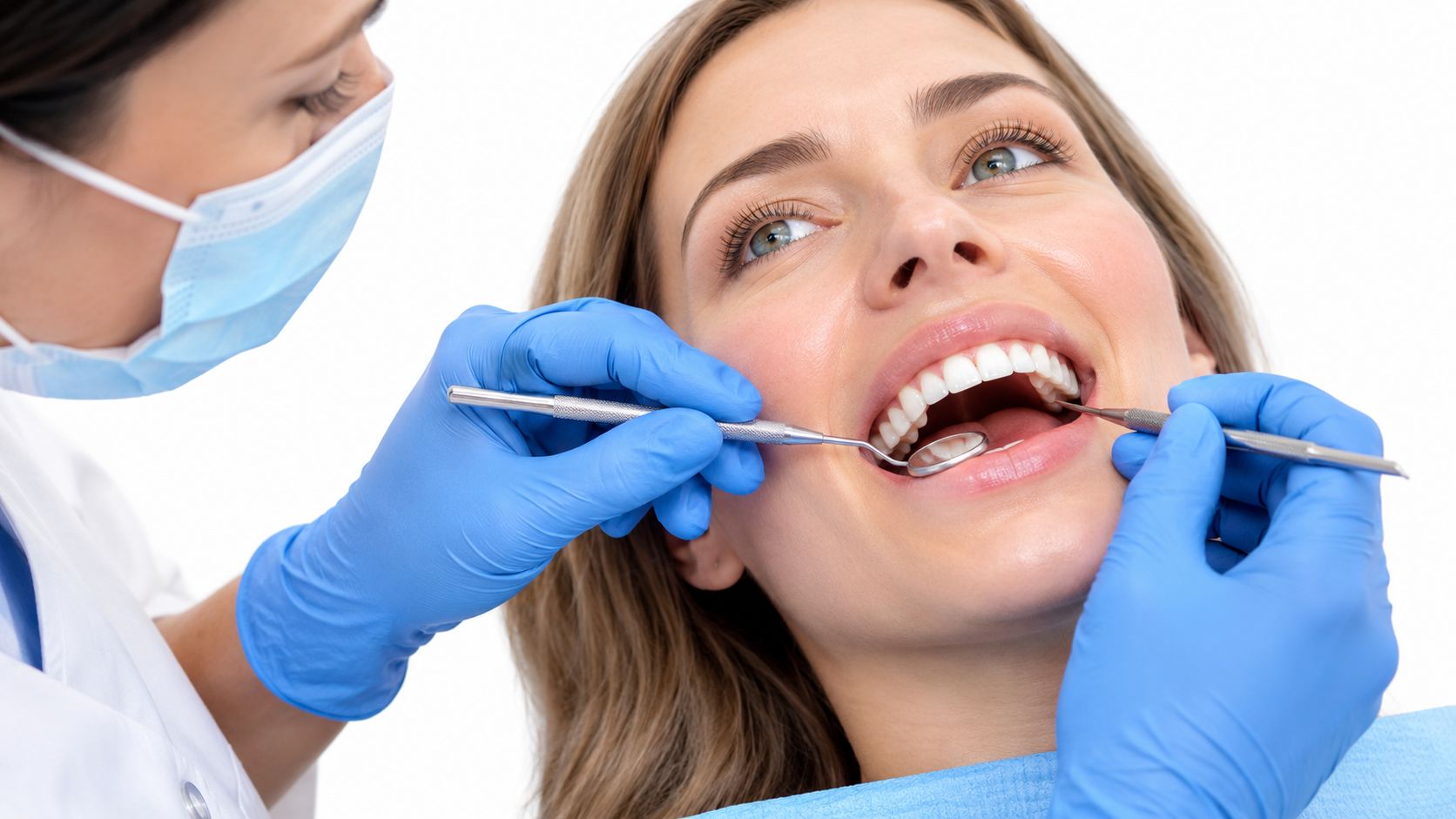 A professional dentist wearing blue gloves and a mask performing a dental examination on a female patient.