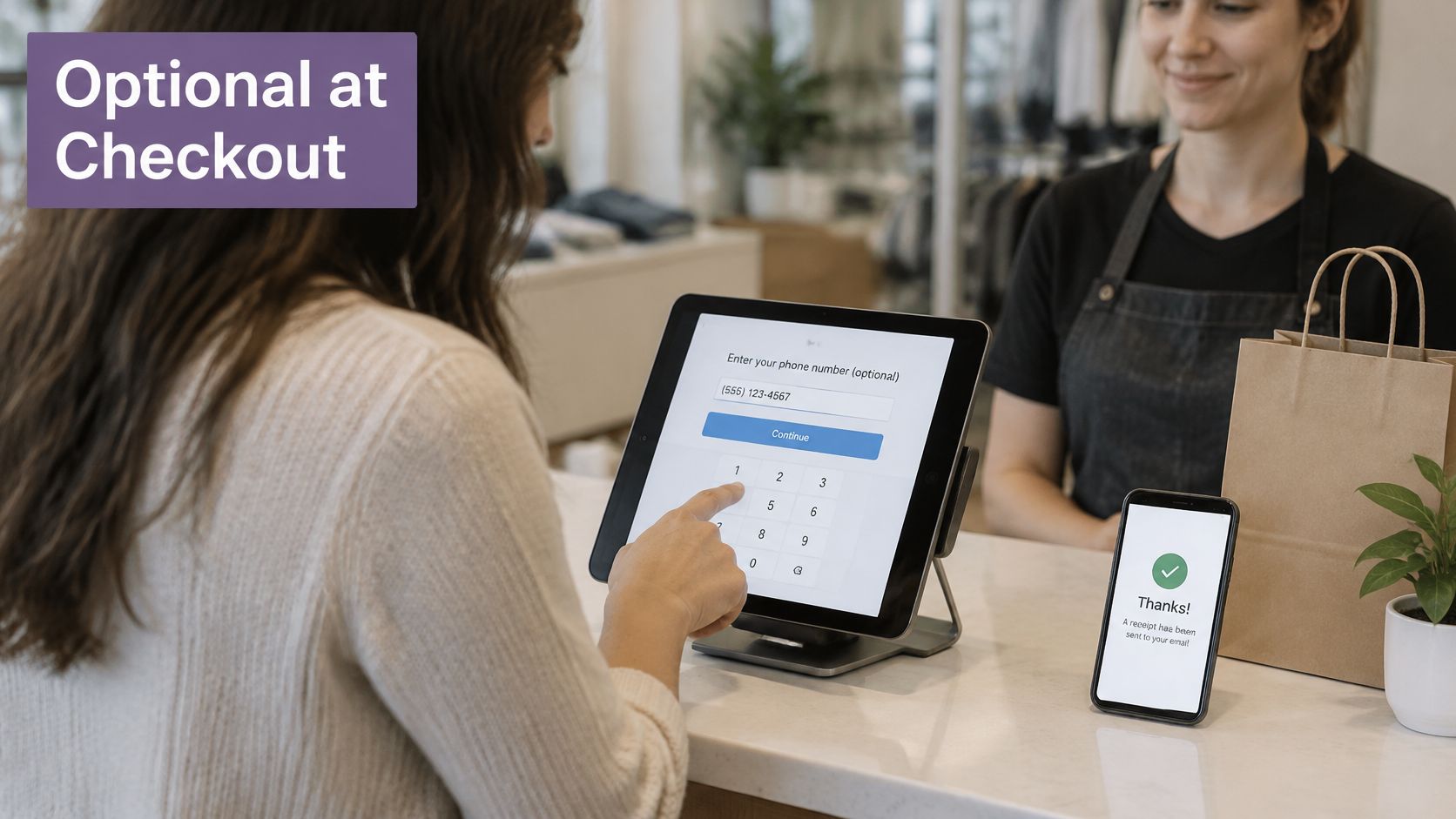A customer entering their phone number on a point-of-sale tablet while shopping at a boutique store.