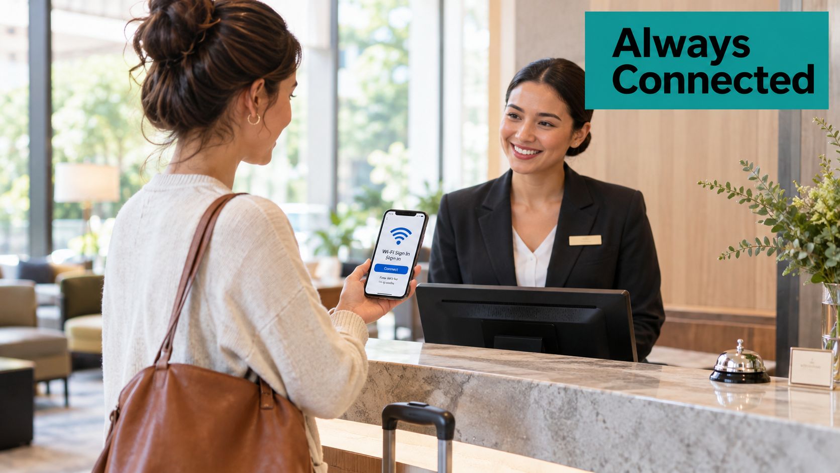 A hotel receptionist smiling at a guest holding a smartphone showing a Wi-Fi sign-in screen.