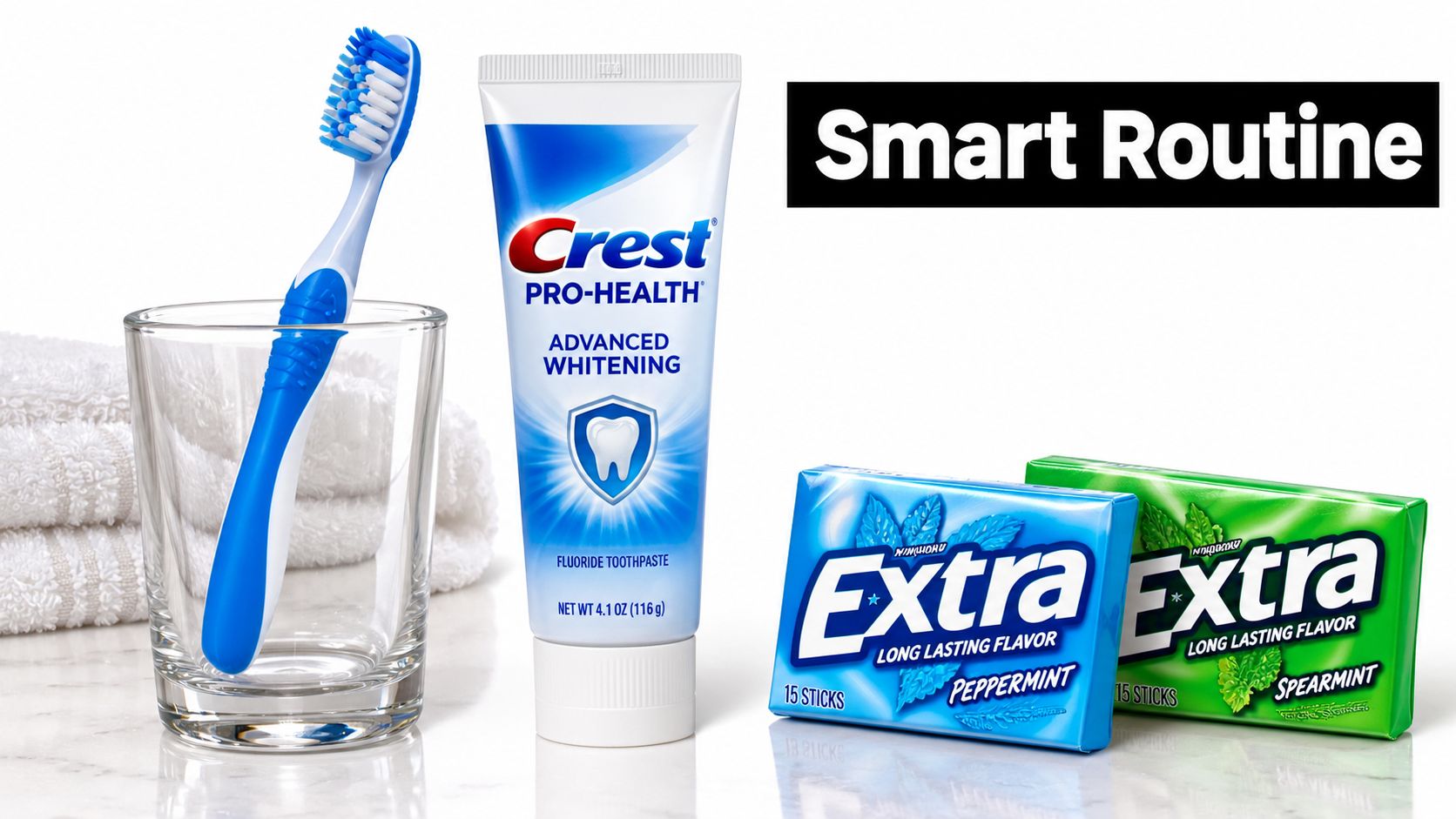 A toothbrush in a glass, a tube of Crest toothpaste, and two packs of Extra gum.