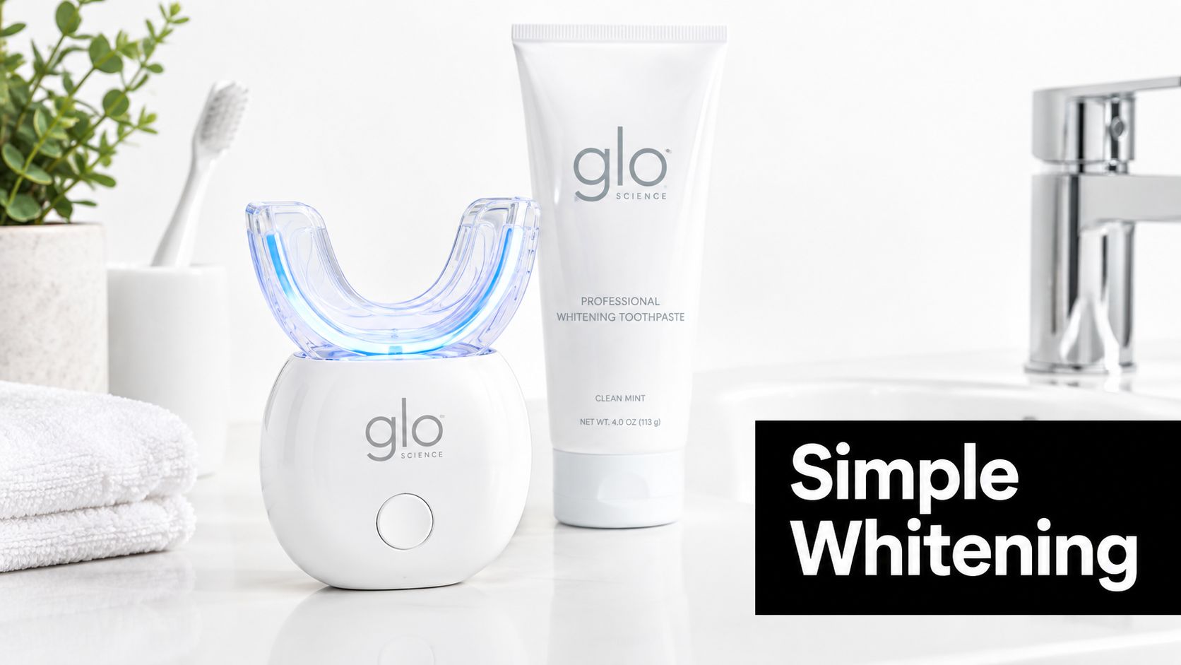 A GLO Science teeth whitening device and a tube of professional whitening toothpaste on a bathroom counter.