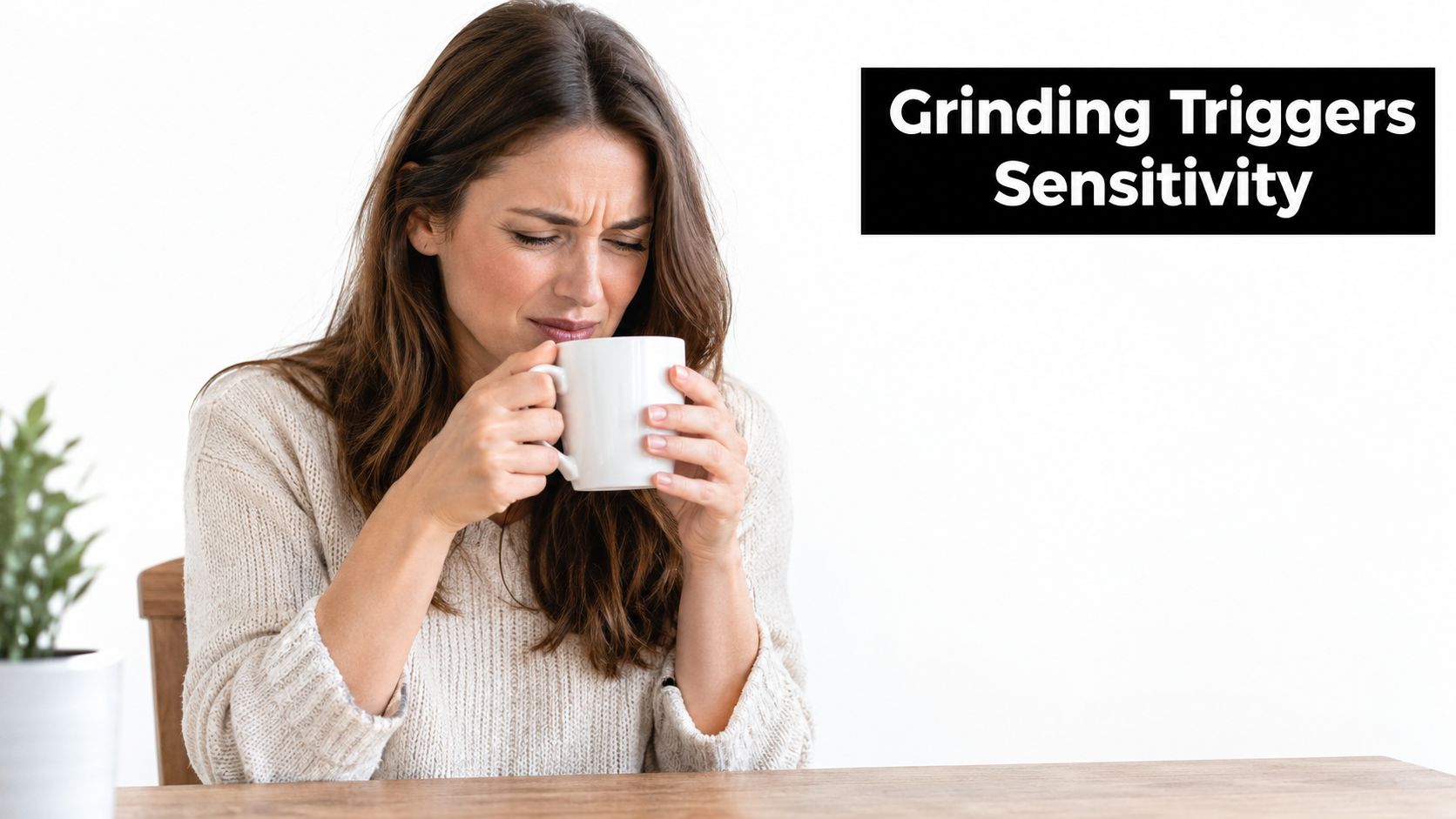 A woman grimacing in pain while holding a warm mug of coffee due to tooth sensitivity.