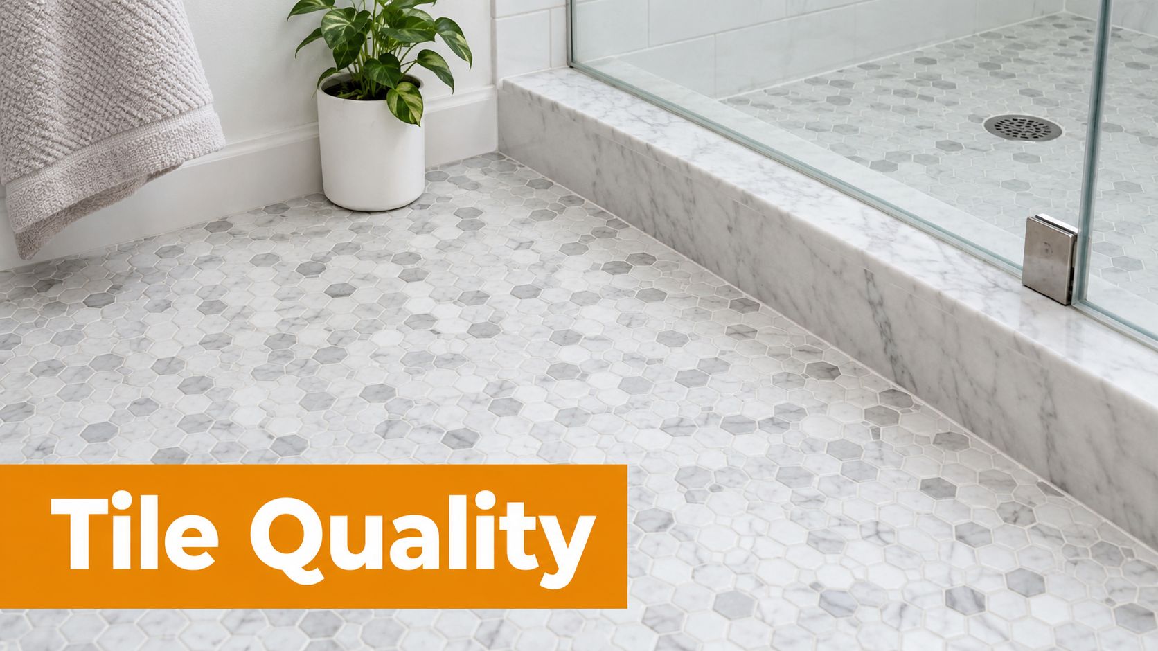 A close up view of white and grey hexagonal marble mosaic tiles on a bathroom floor.