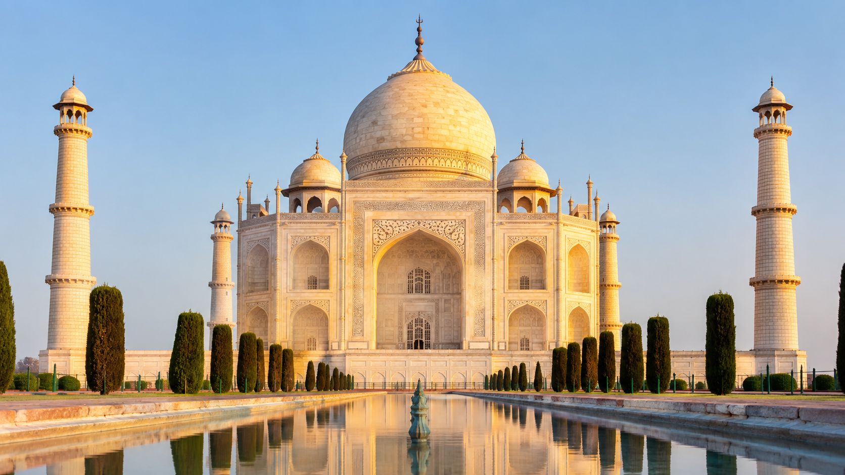 The majestic Taj Mahal in Agra, India, featuring its iconic white marble dome and reflecting pool.