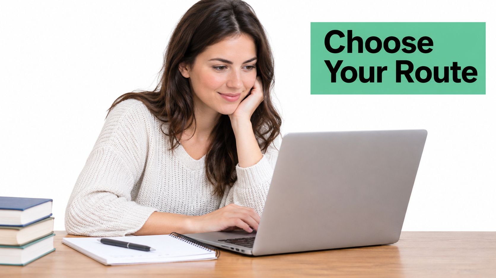 A young woman sits at a desk while smiling and using a laptop to study healthcare courses online.