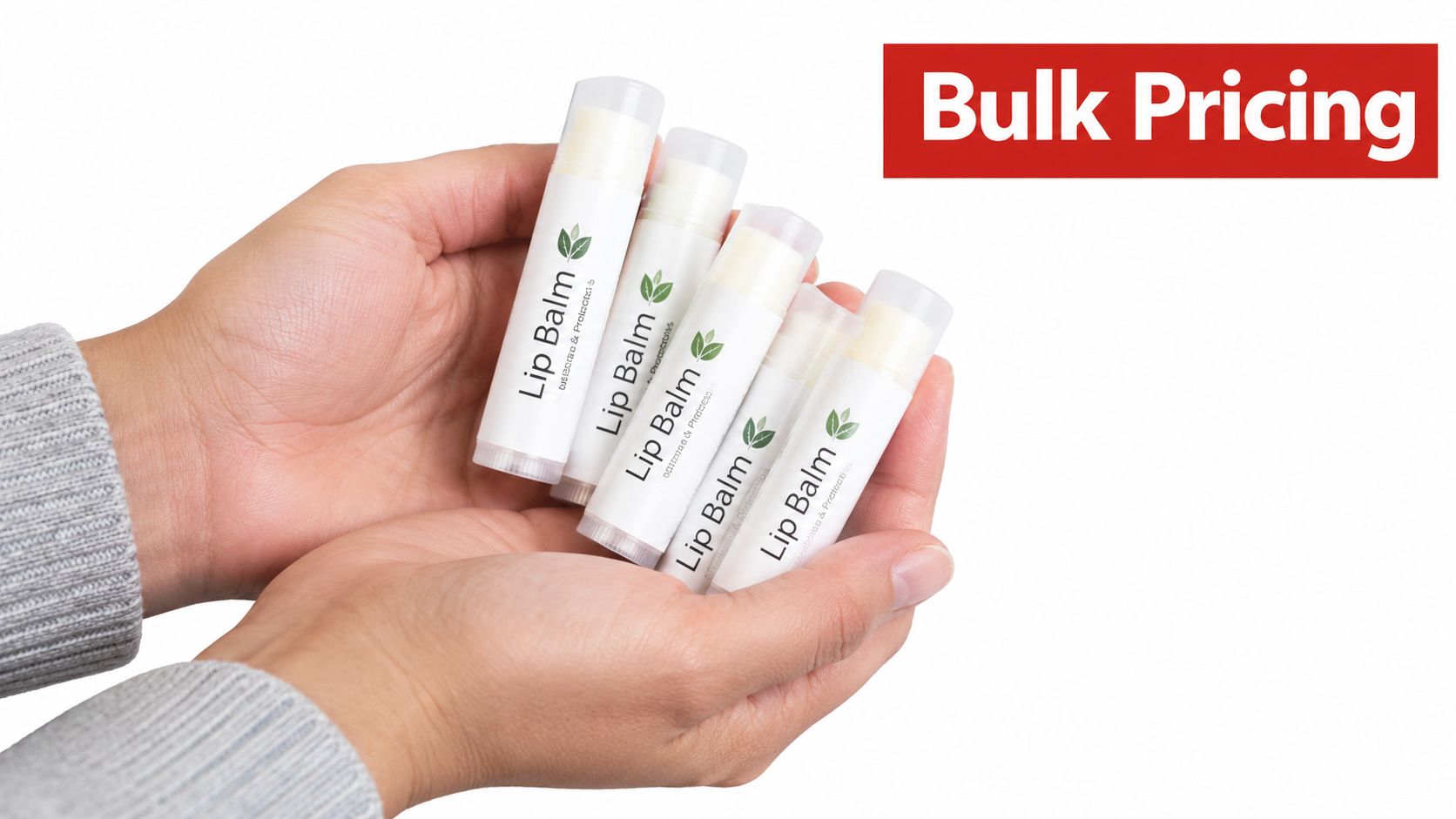 A person holding five white tubes of promotional lip balm with green leaf logos in their hands.