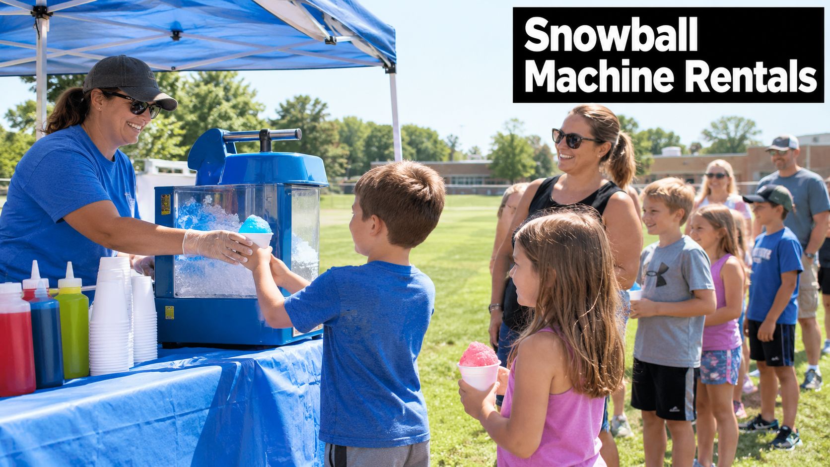 A woman serving blue snow cones to children at a park event with a shaved ice machine.