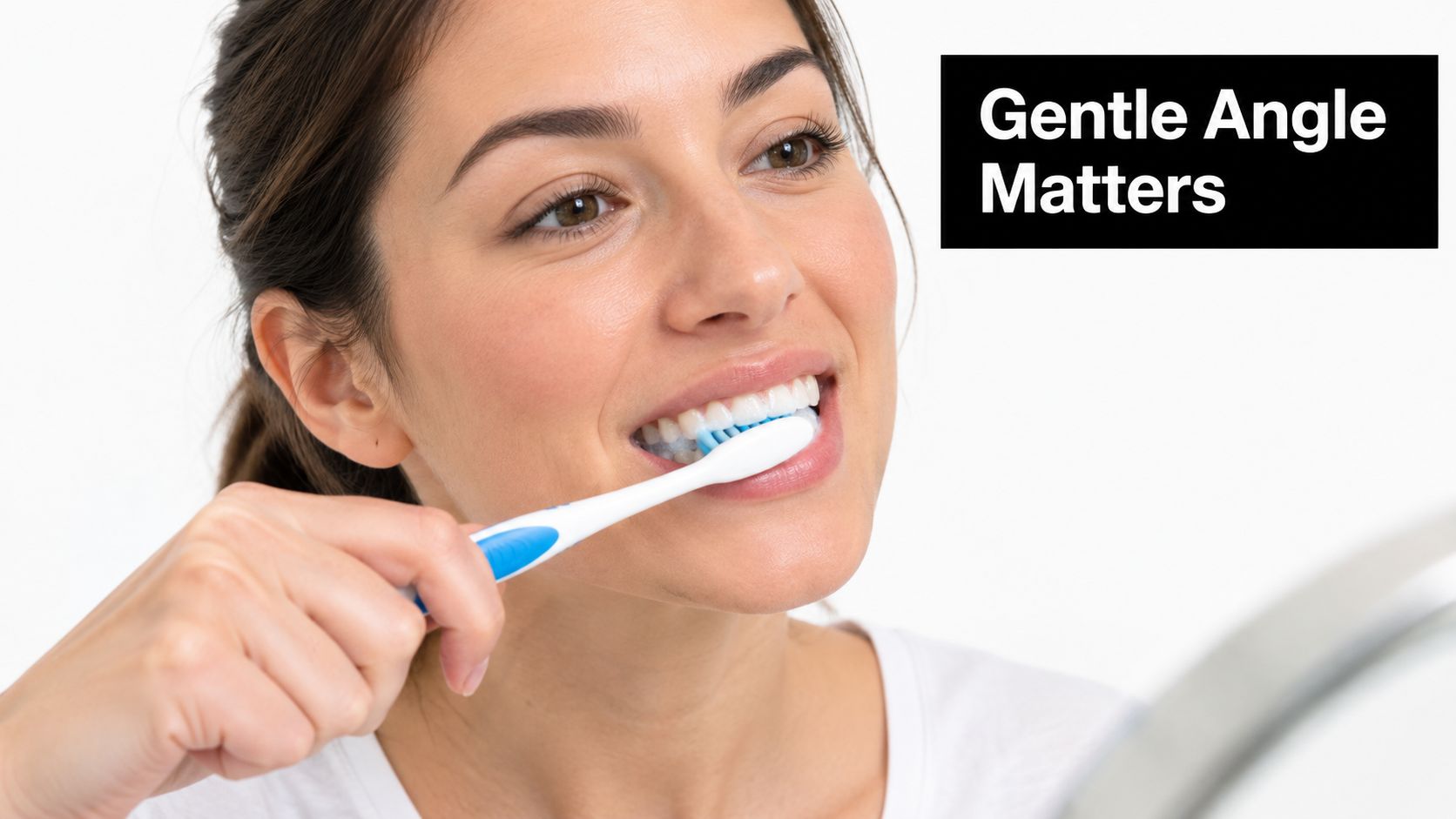 A woman smiling while gently brushing her teeth with a toothbrush, illustrating proper dental care techniques.