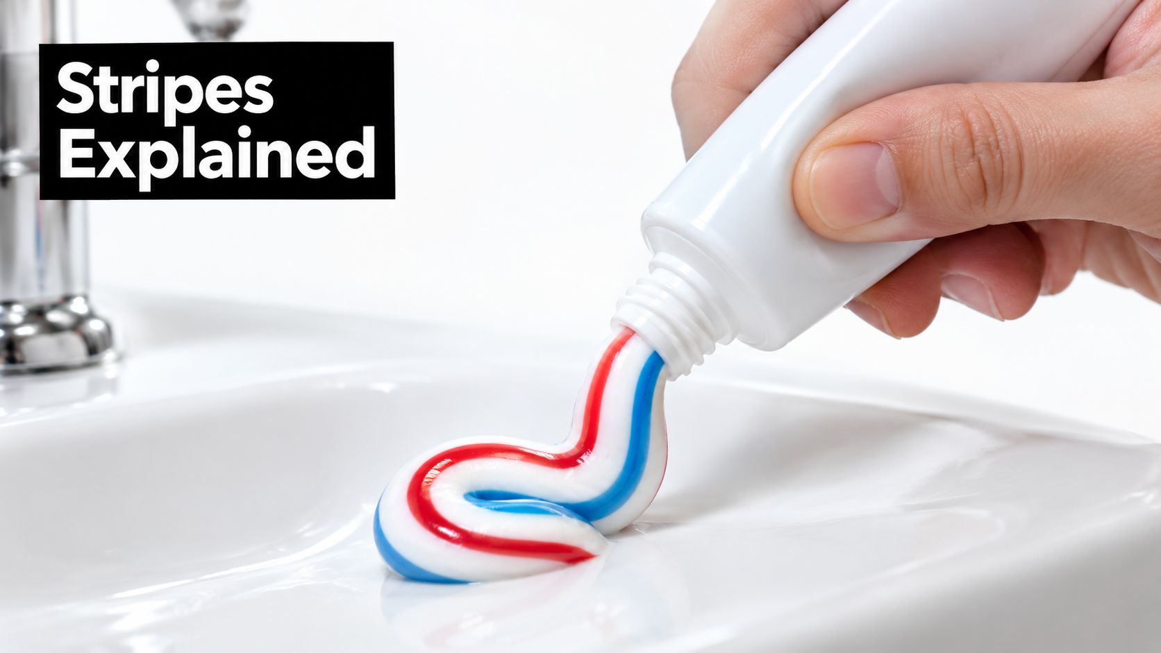 A hand squeezing a white tube of tri-colored red, white, and blue toothpaste onto a bathroom sink.