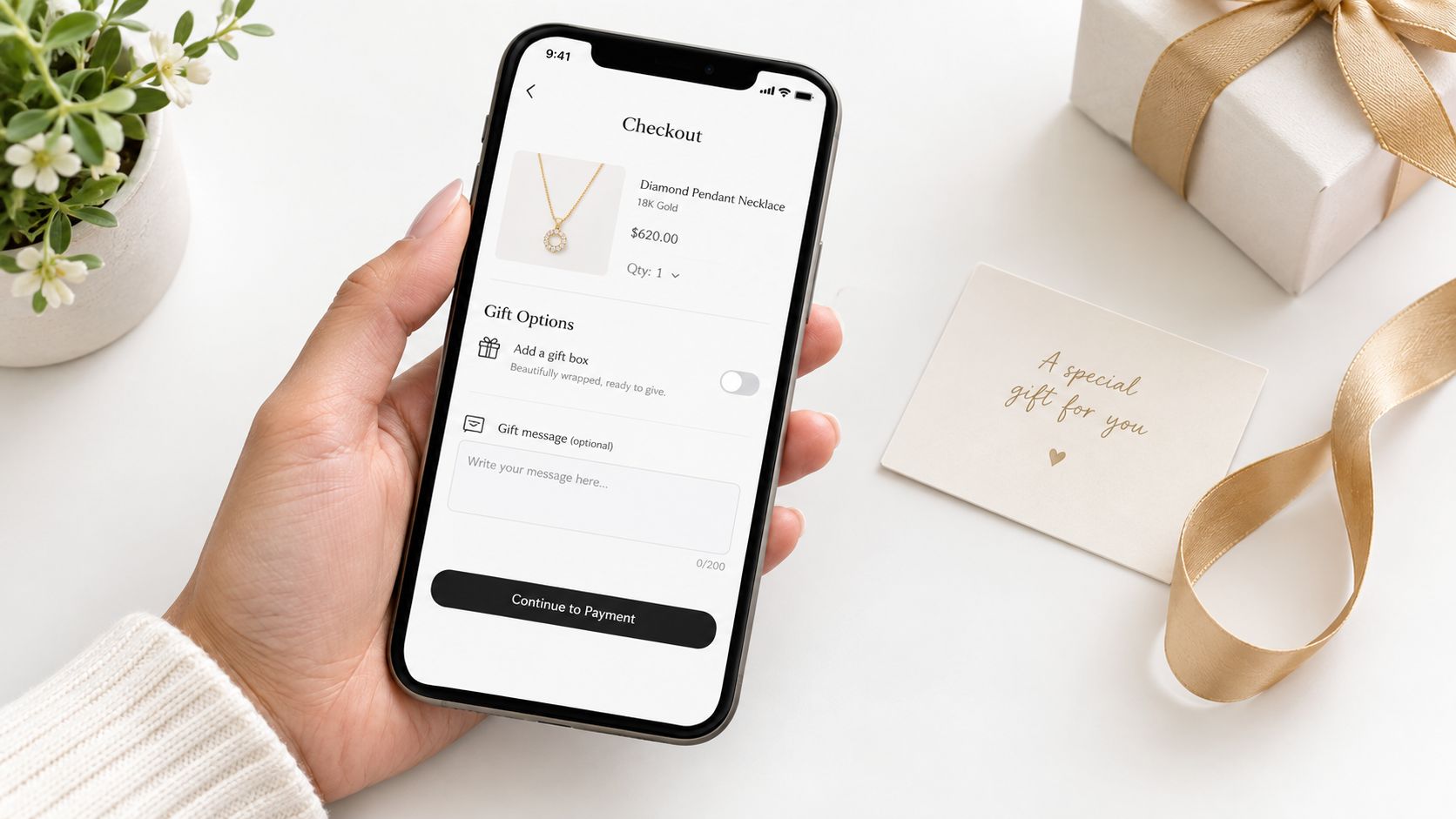 A person holding a smartphone showing a jewelry store checkout page with gift options and a card.