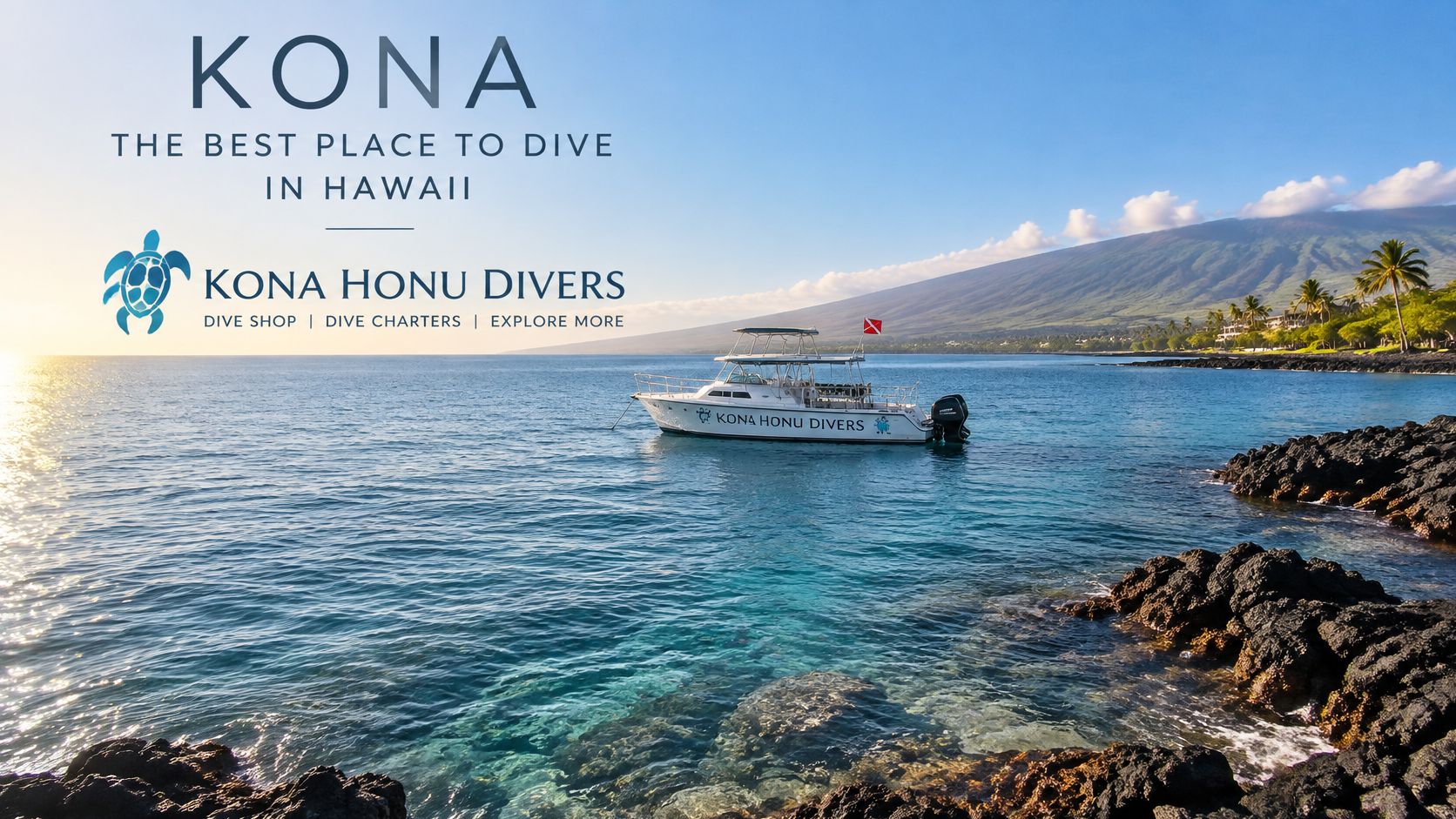 A white dive boat floats on calm, clear blue water near a volcanic rocky coastline in Hawaii.