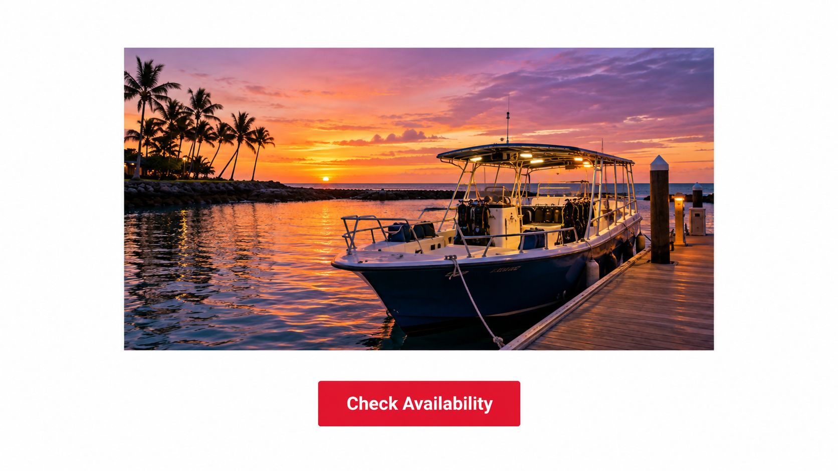A scuba diving boat docked at a marina during a vibrant orange sunset in Hawaii.