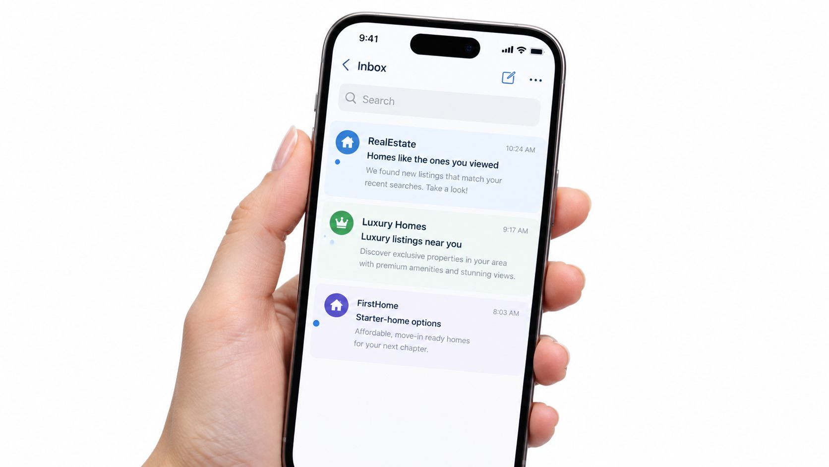 A hand holding a smartphone showing an email inbox app with personalized real estate listing notifications.