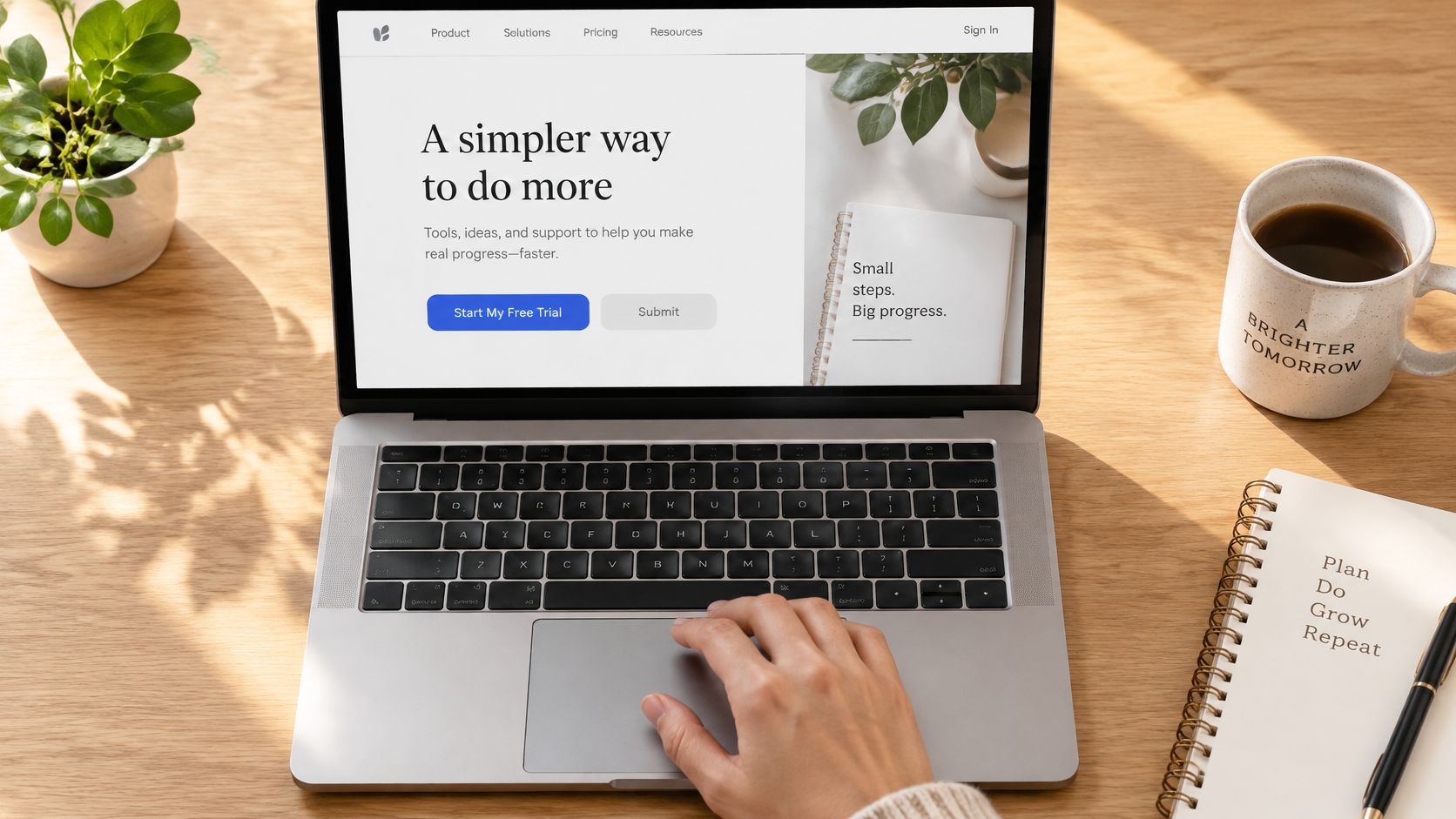 Person working on a laptop displaying a website with productivity-focused messaging and clean user interface design.